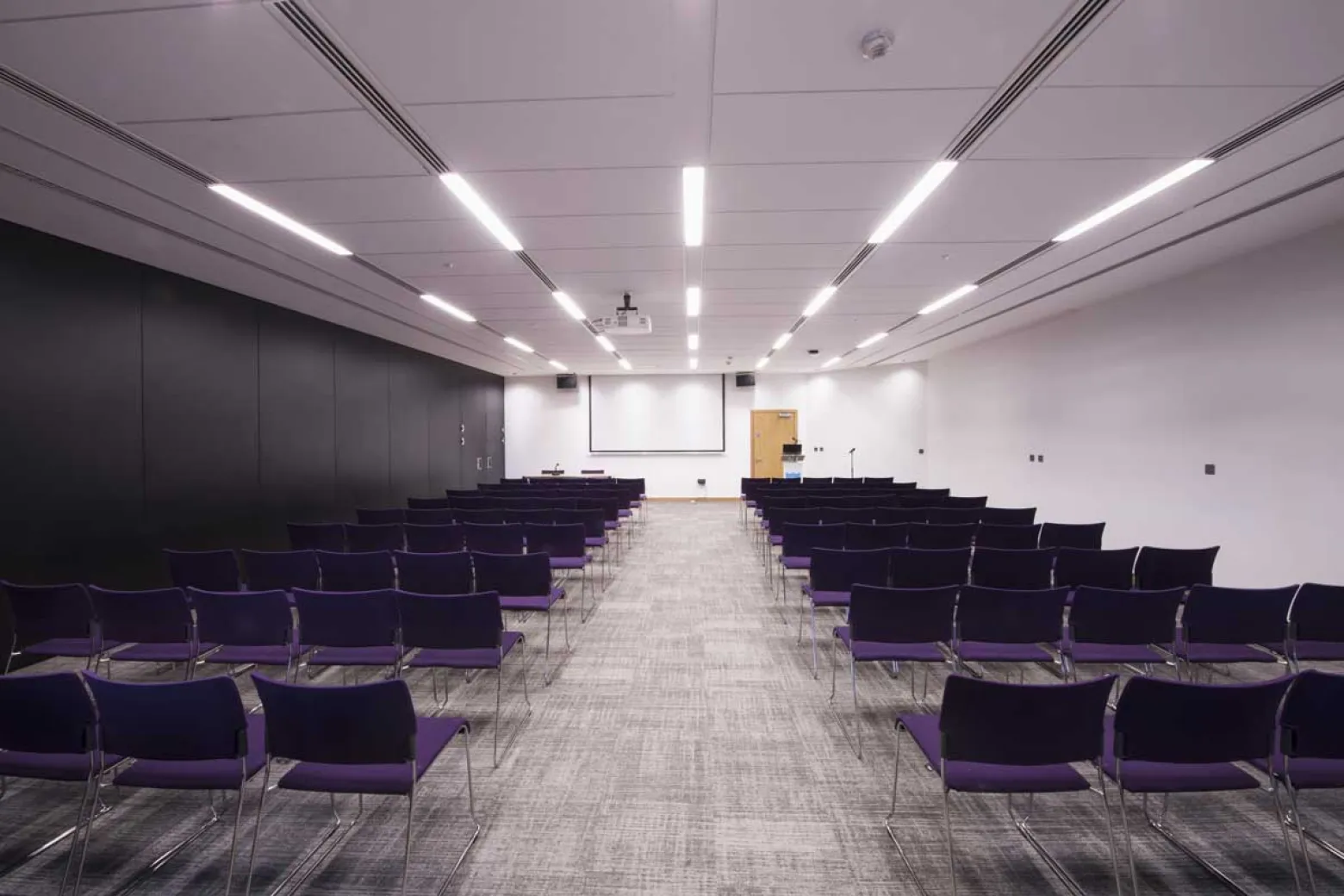 Modern meeting space with purple chairs at ICC Belfast for conferences and workshops.