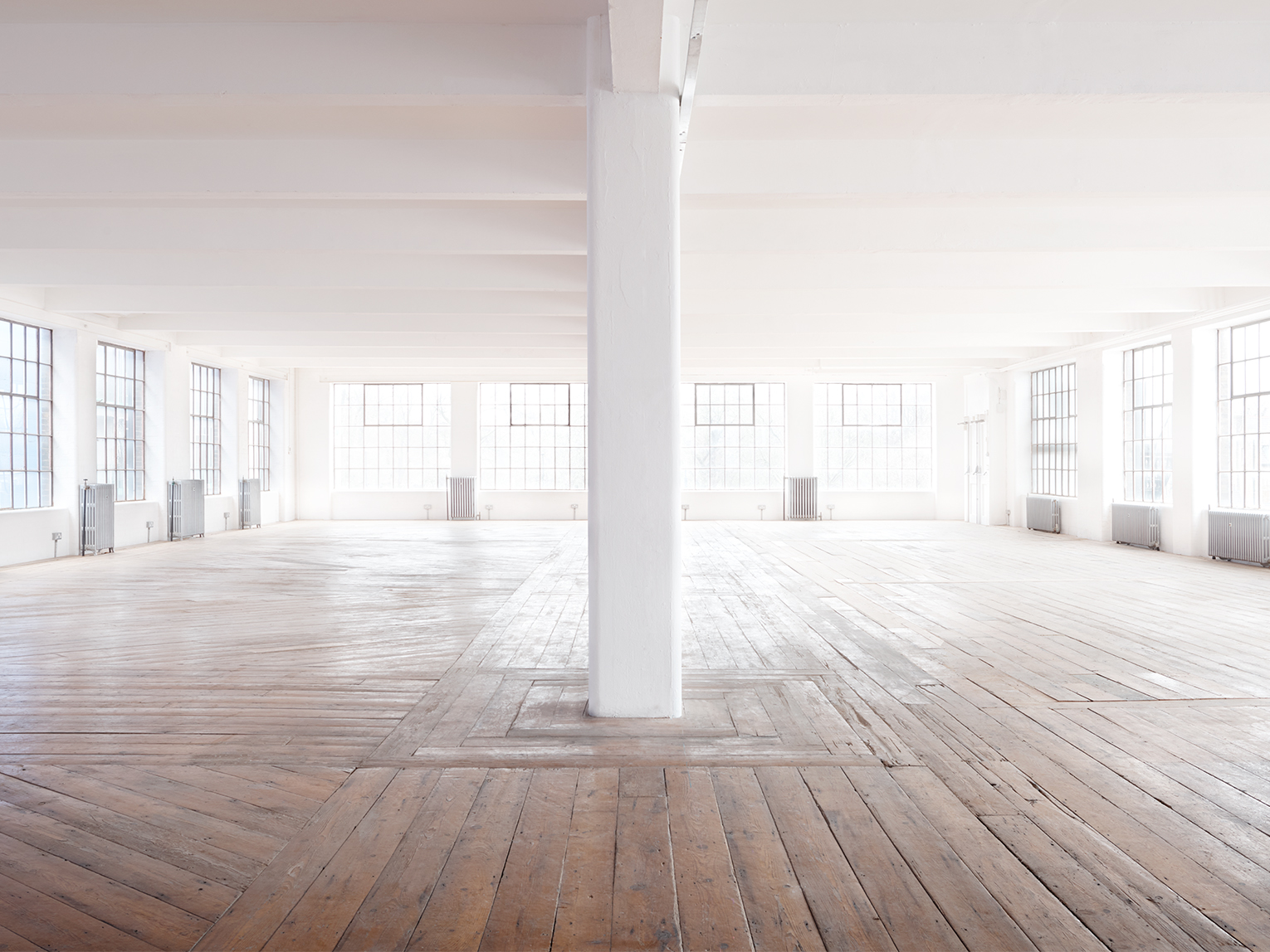 Studio 2 industrial blank canvas venue with hardwood floors for events and photoshoots.