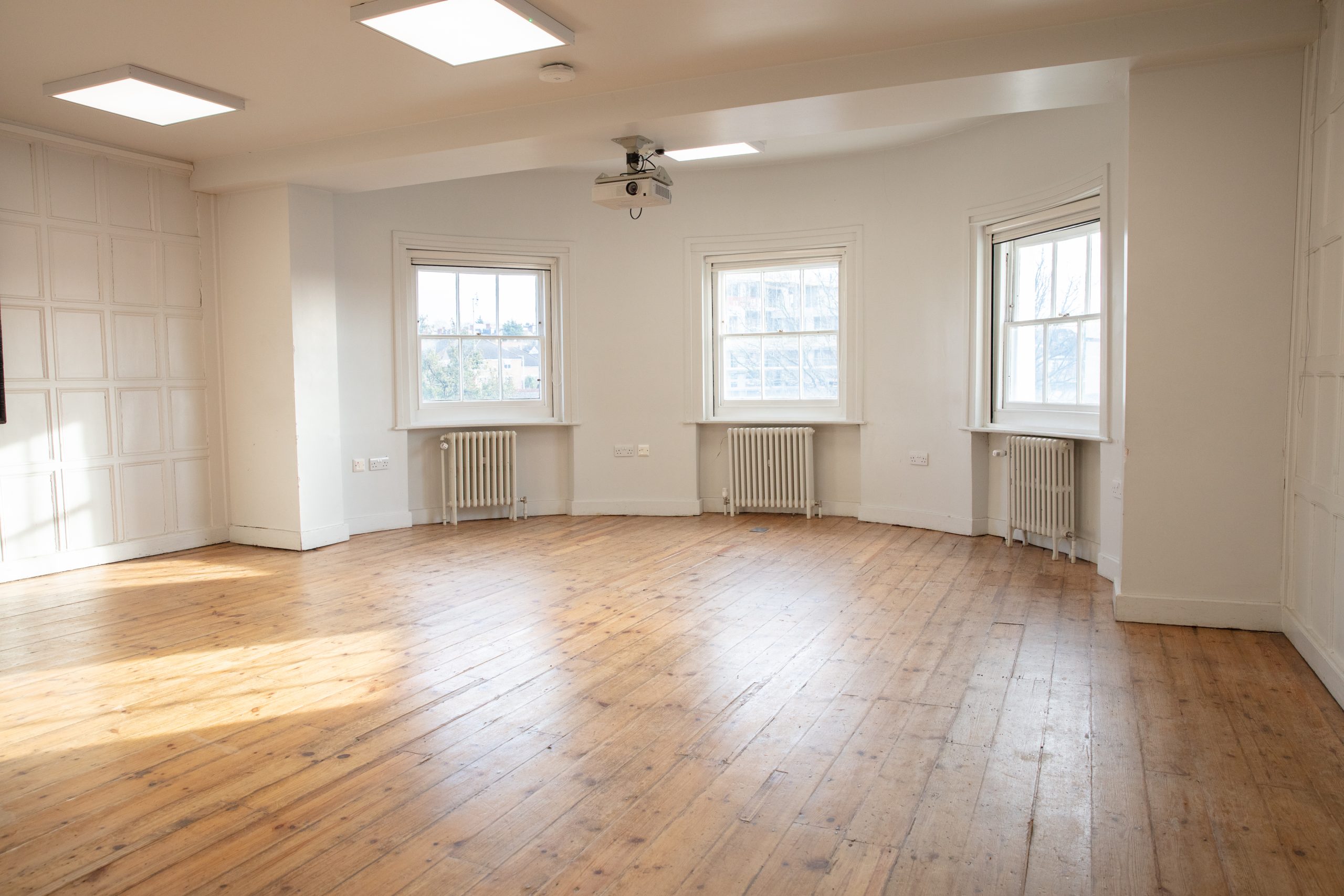 Acanthus event space with natural light and wooden floor, ideal for workshops and gatherings.