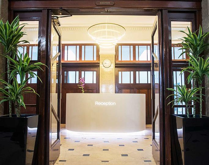 Modern boardroom reception area with natural light, perfect for meetings and events.