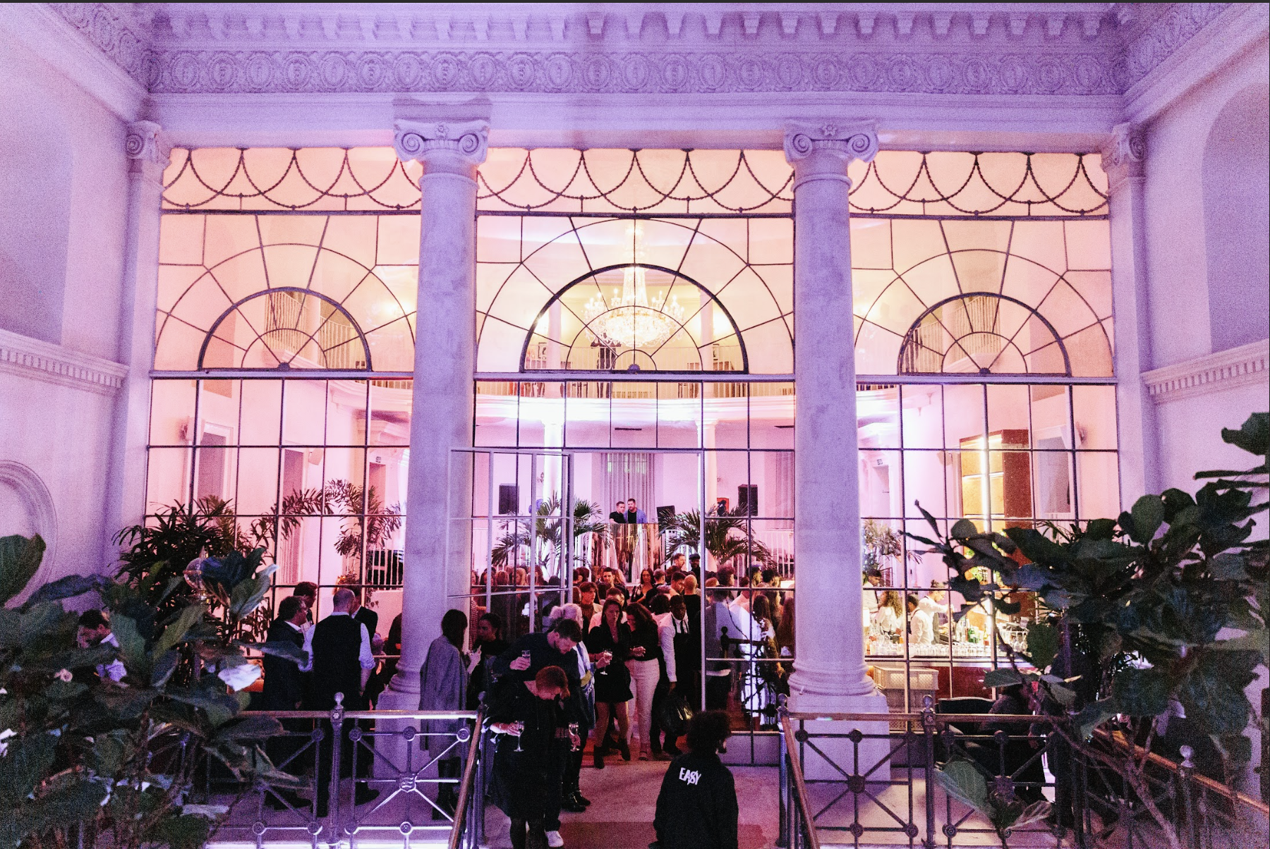 Elegant event space at Old Sessions House with pink lighting, perfect for networking and parties.