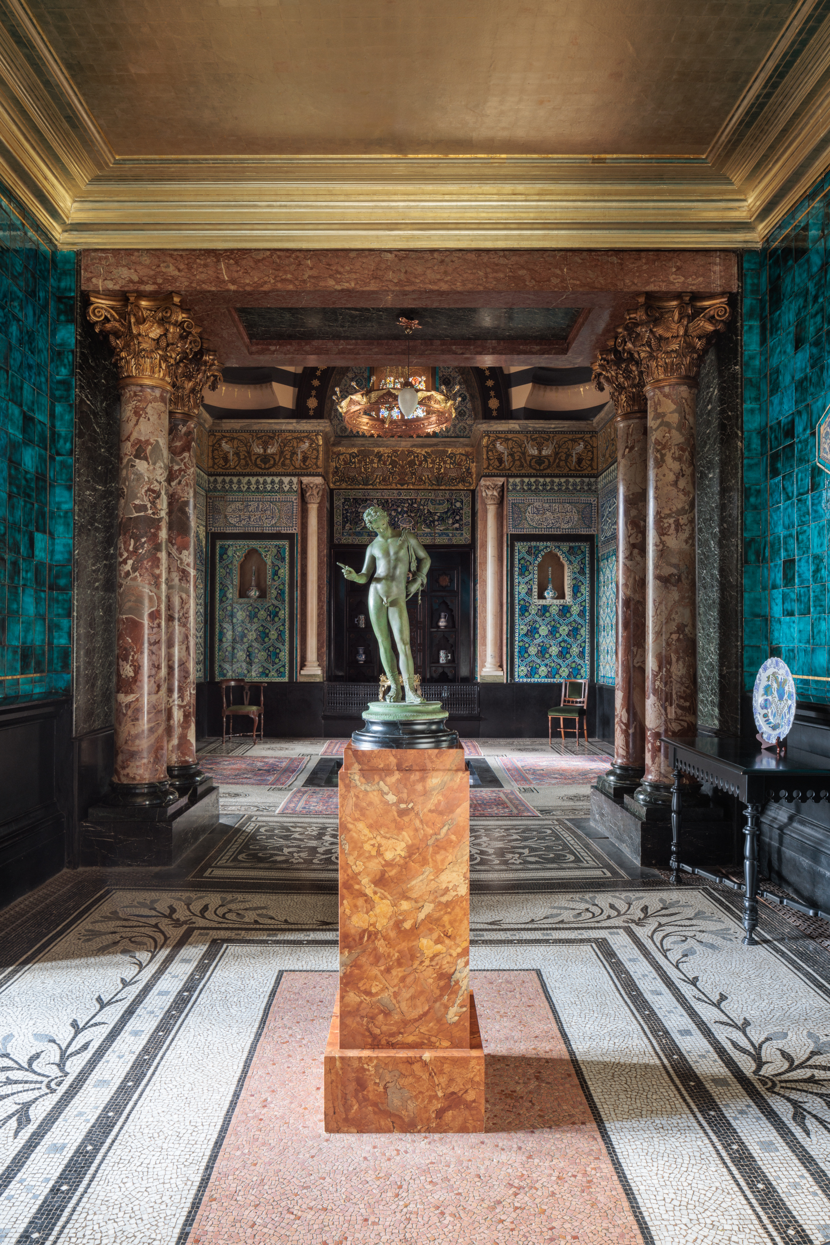 Christmas party venue in Leighton House with elegant marble columns and rich decor.