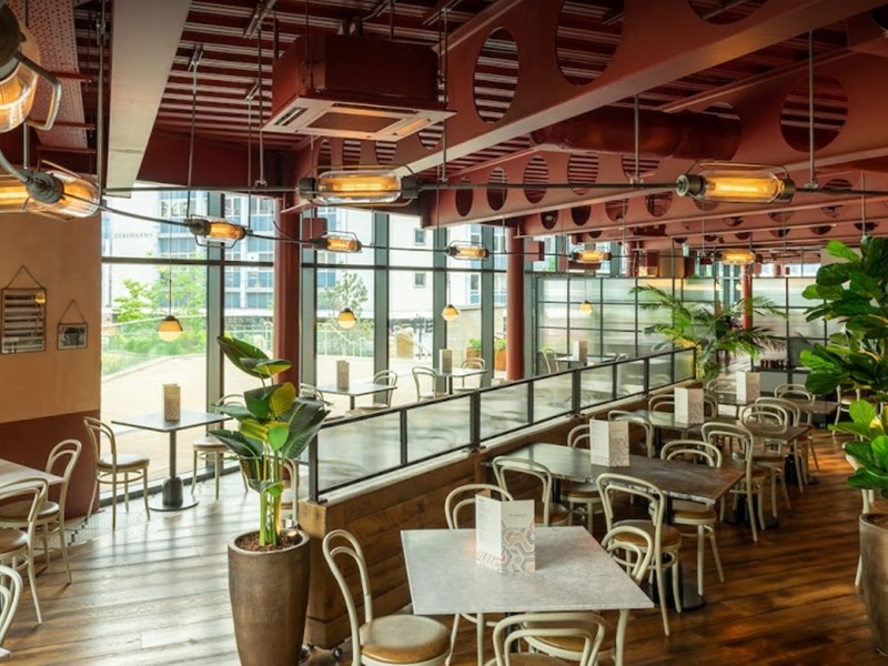 Modern event space with large windows, perfect for meetings and social gatherings.