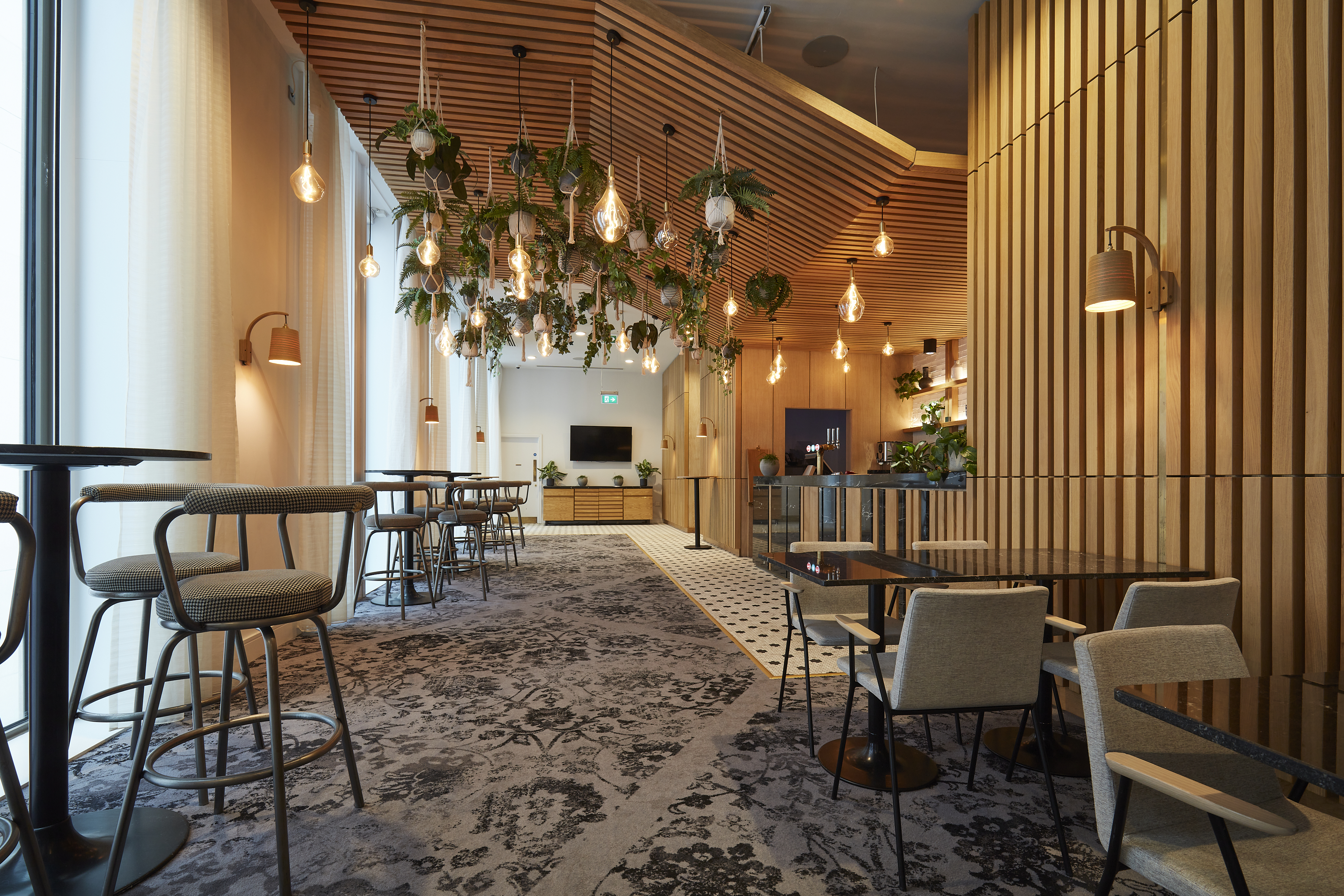 Modern event space at Salvation Bar, Manchester with warm wood accents and natural light. - Banner