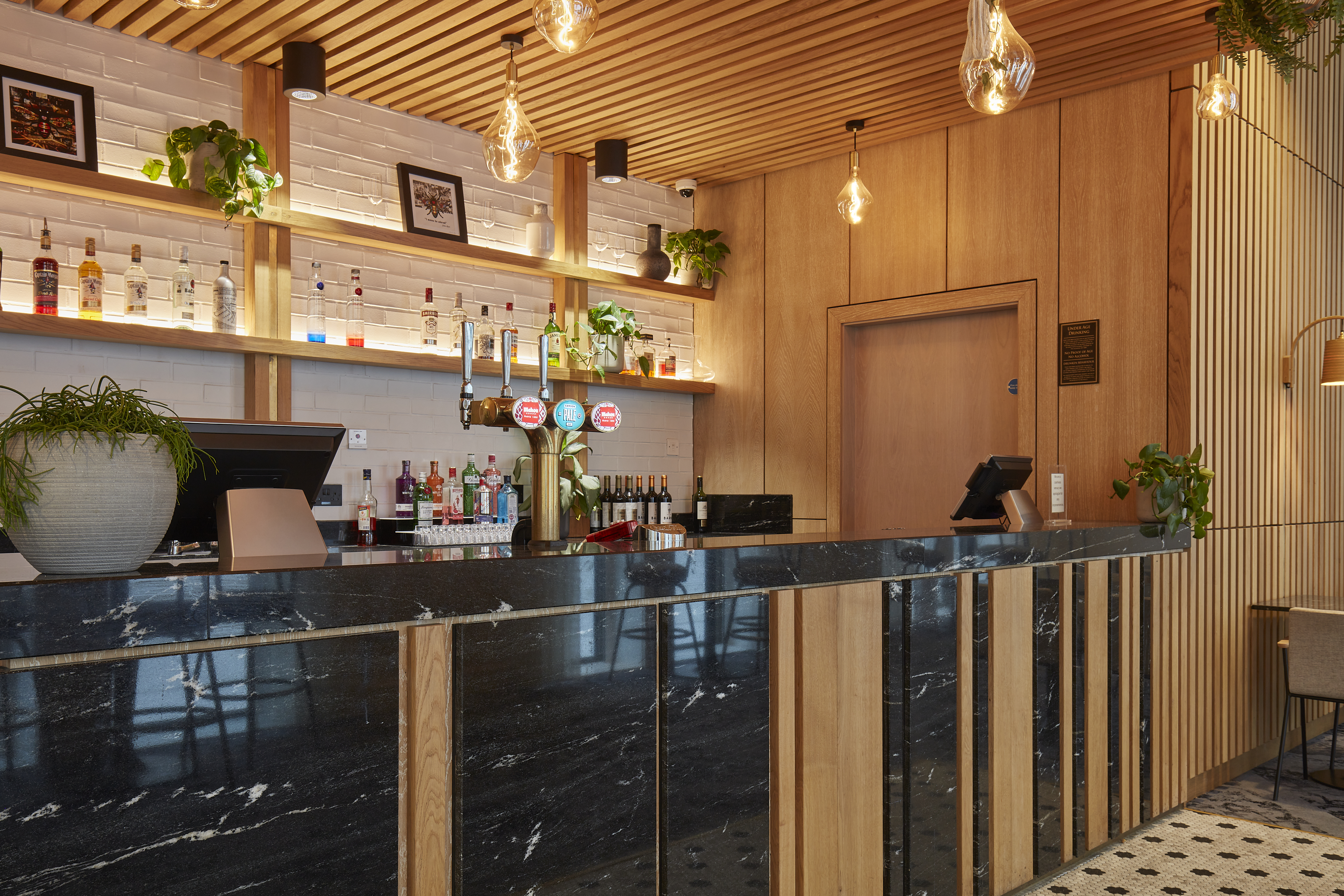 Stylish Salvation Bar with marble counter, ideal for networking events in Manchester. - Banner