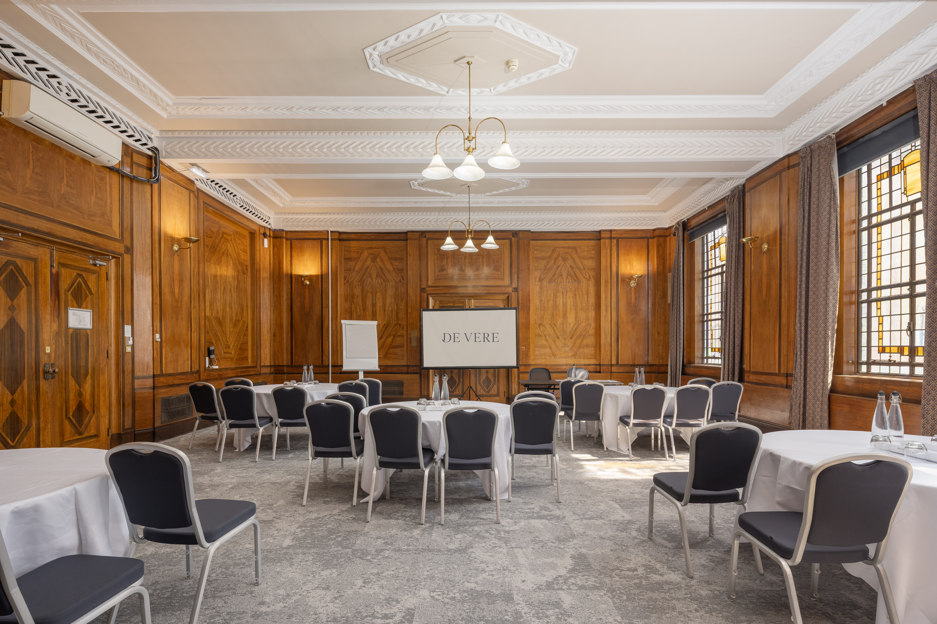 Devon Suite boardroom, wood-paneled, for corporate meetings and strategy workshops.