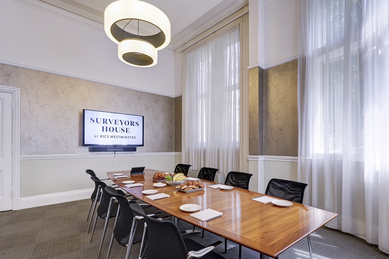 Minimalist Dubai boardroom with high ceilings for executive meetings and corporate presentations.