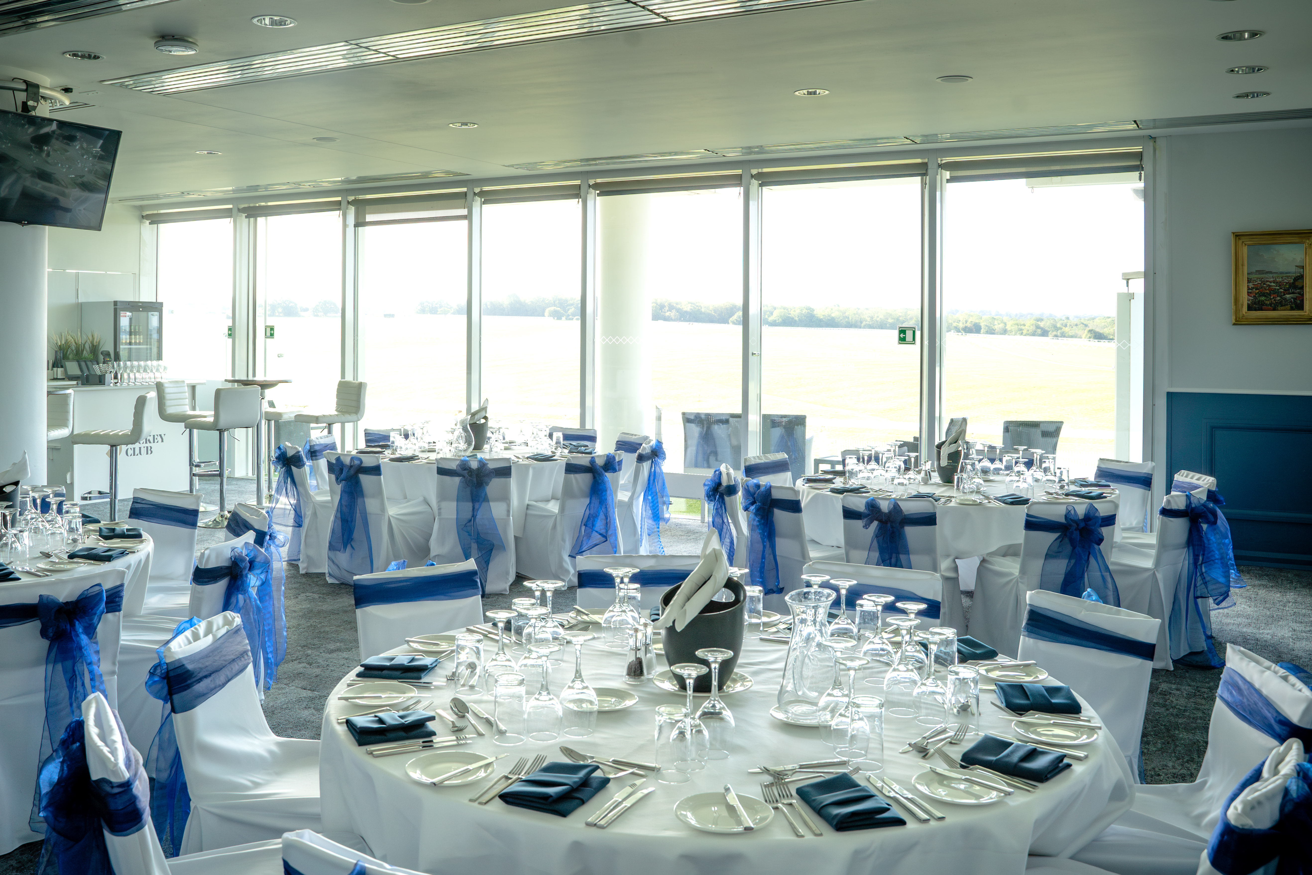 The Boardroom at Epsom Downs Racecourse: elegant corporate banquet space with panoramic views.