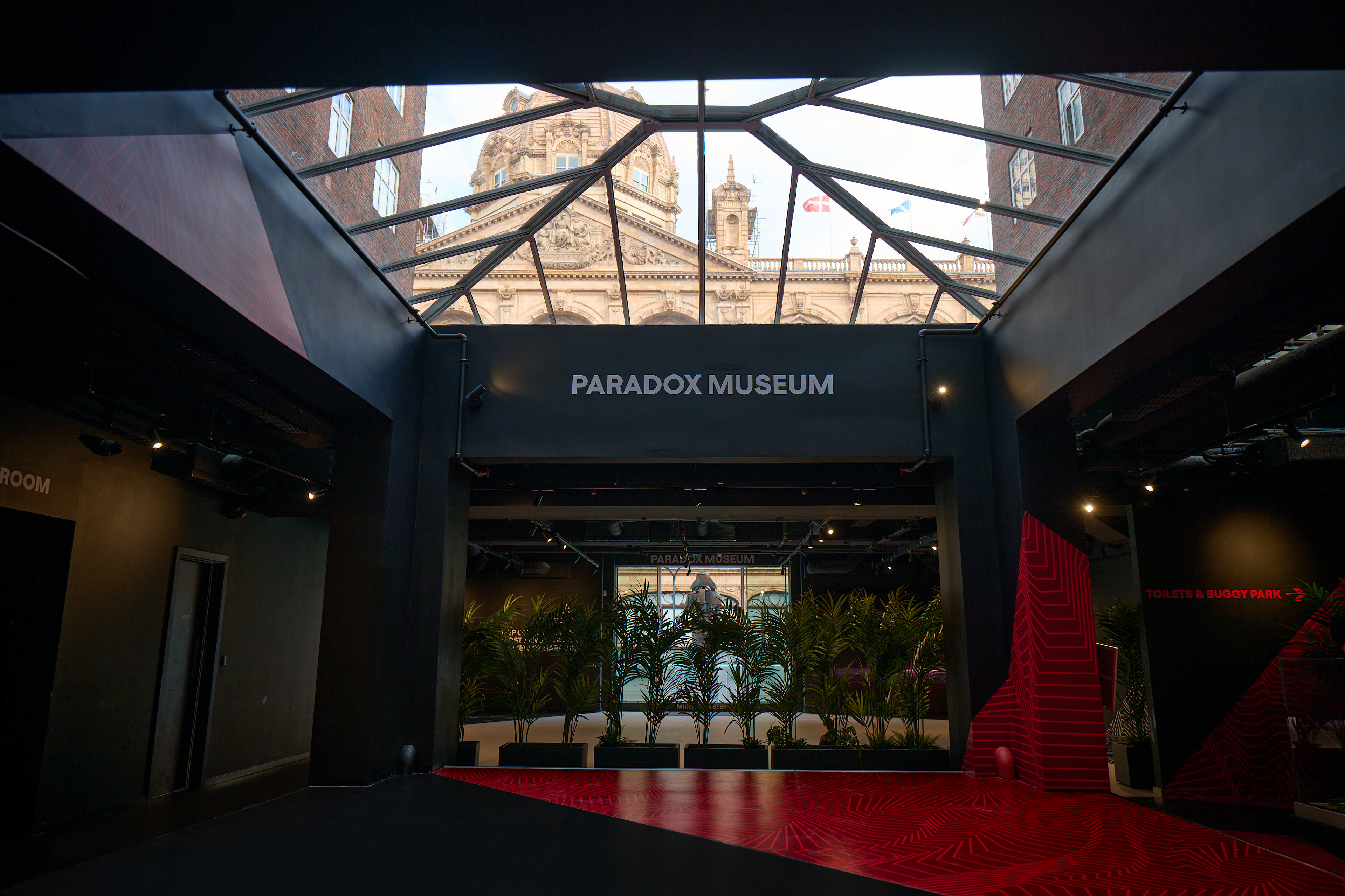 Modern event space with glass ceiling at Paradox Museum London for immersive meetings.