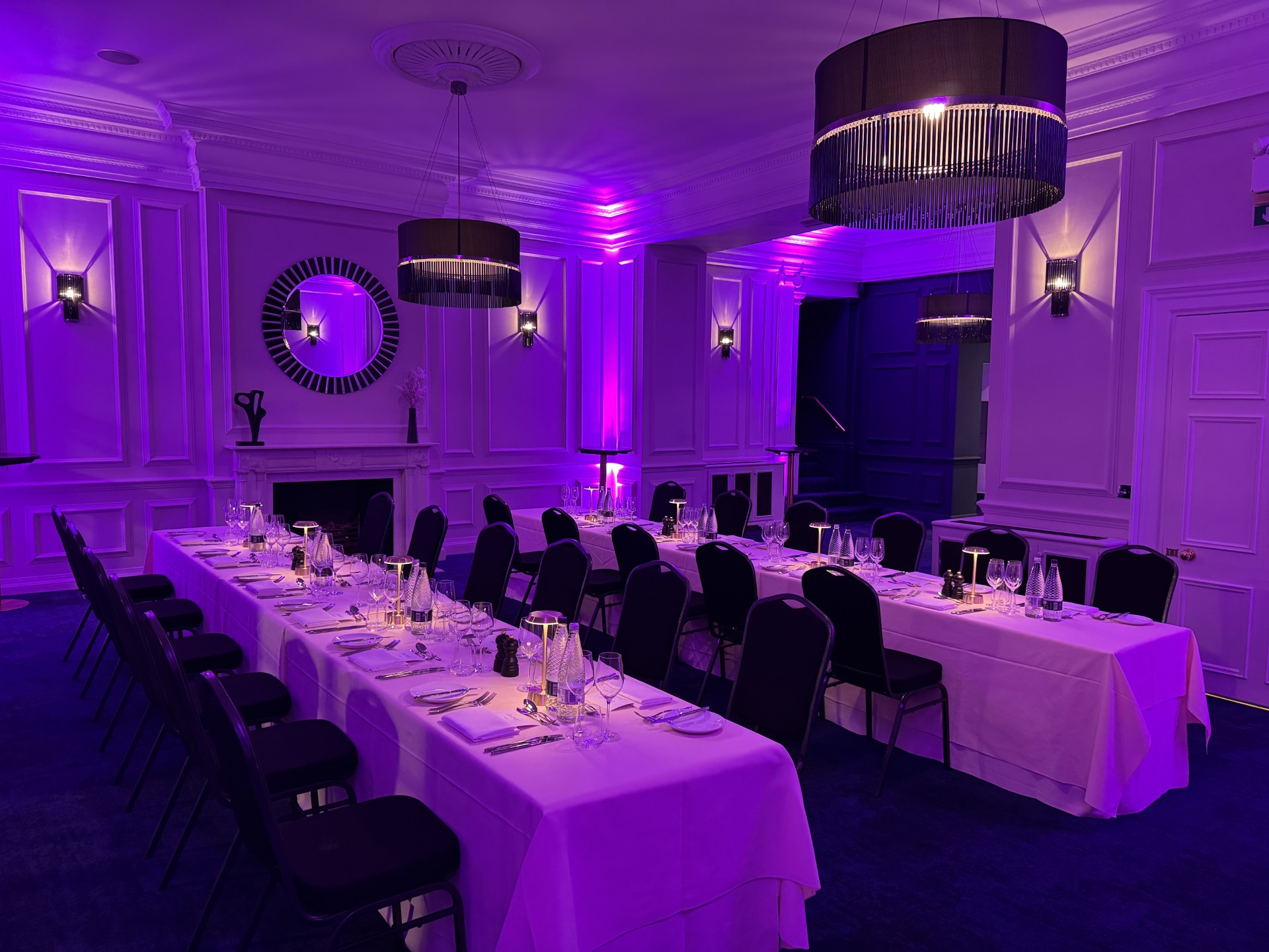 Elegant banquet, purple uplighting, gala reception, conference venue.