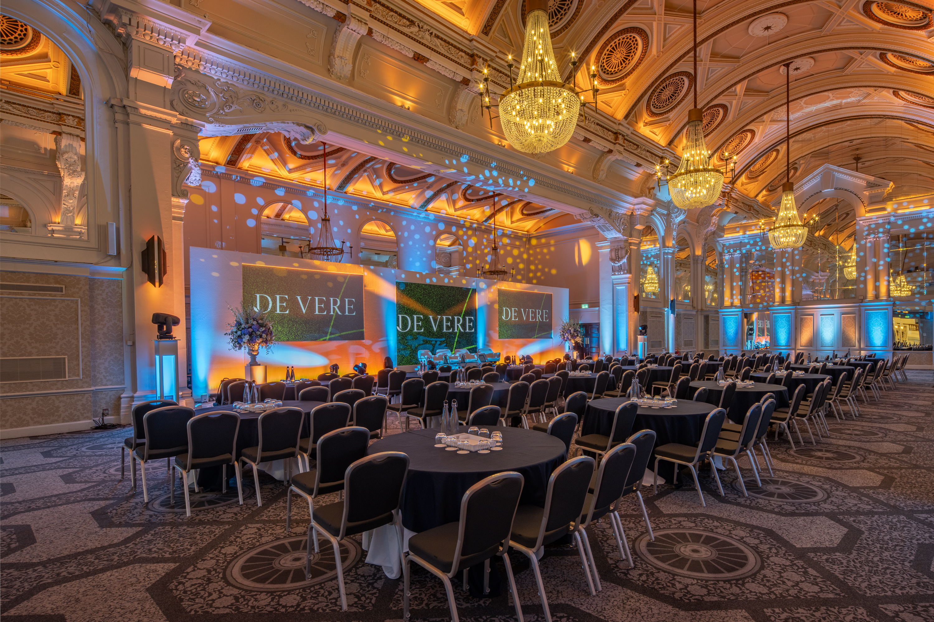 Grand Connaught Rooms ballroom set for corporate gala with ornate heritage architecture.