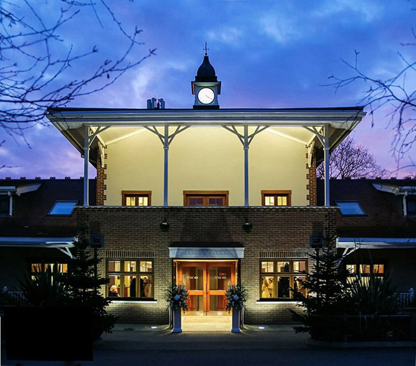 Olympic Pavilion at dusk with clock tower, ideal venue for weddings and corporate conferences.