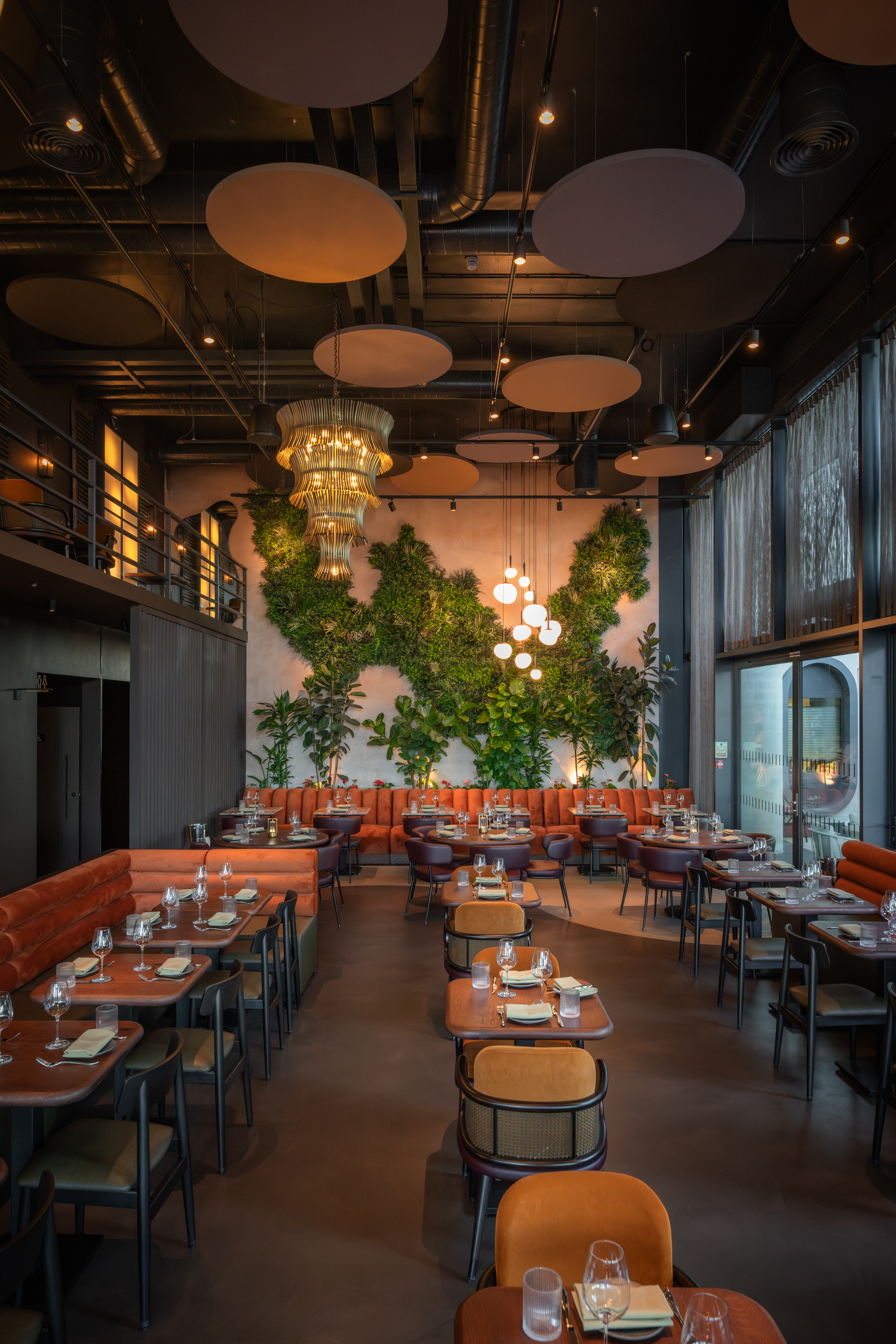 Agora Hall in HERA Restaurant: modern decor, lush greenery, ideal for events.