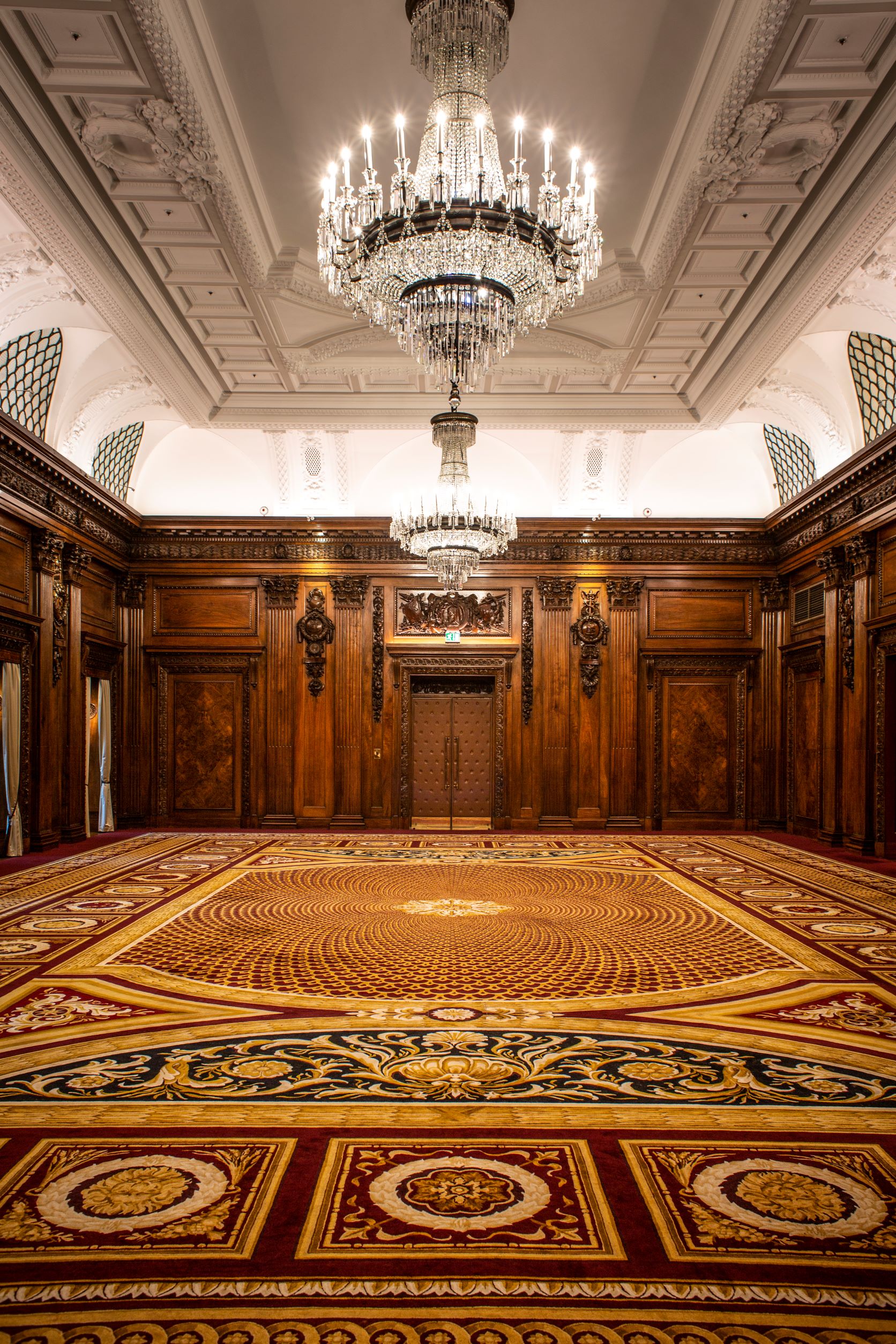 Historic UN Ballroom at Four Seasons London with wood paneling for formal galas and black-tie events.
