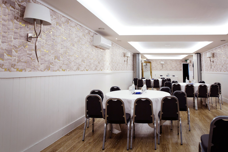 The Vault at Harbour Hotel: round-table breakout space for corporate meetings and private events.