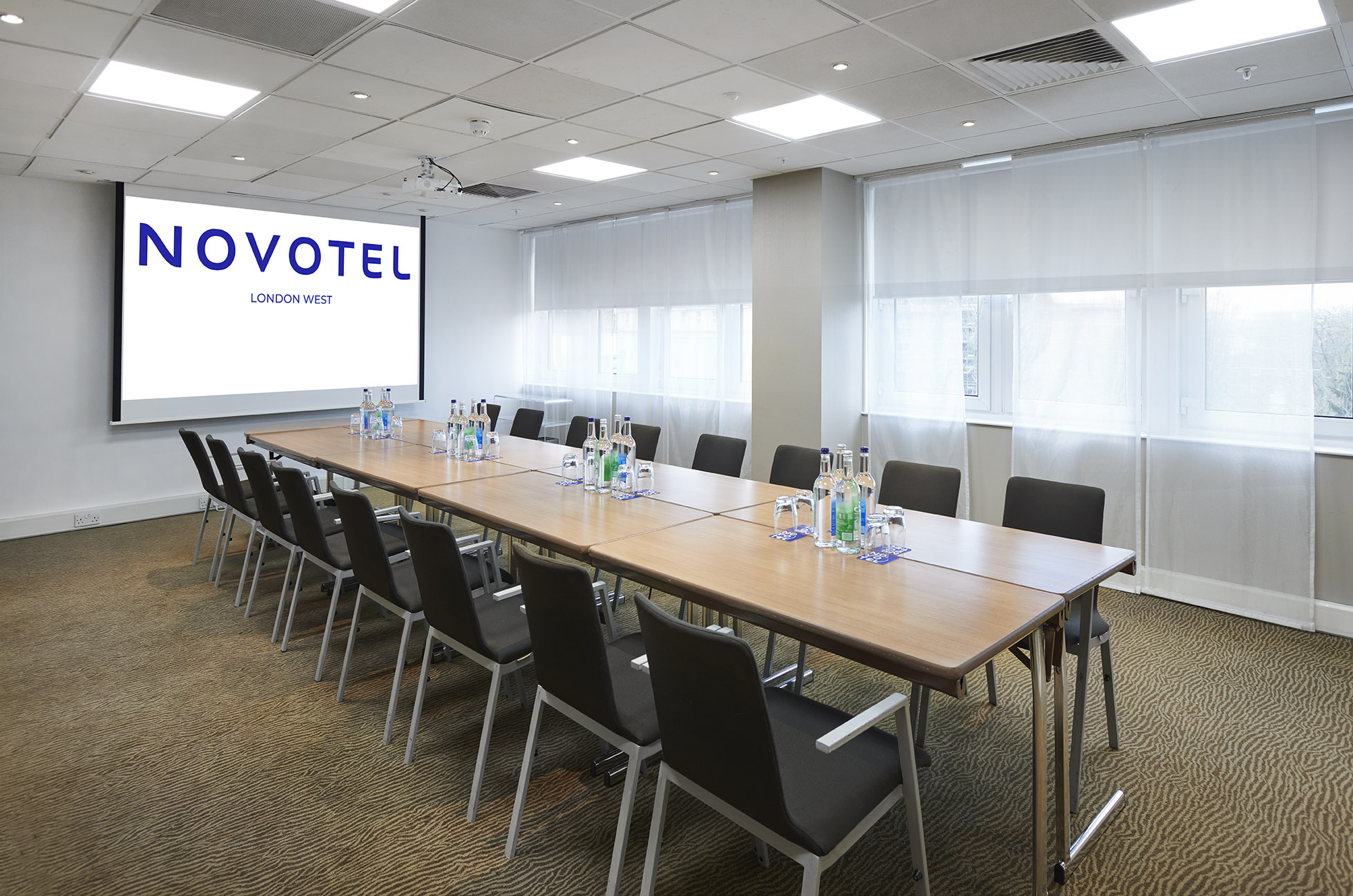 Meeting room at Novotel London West with long table, bright atmosphere, corporate events.