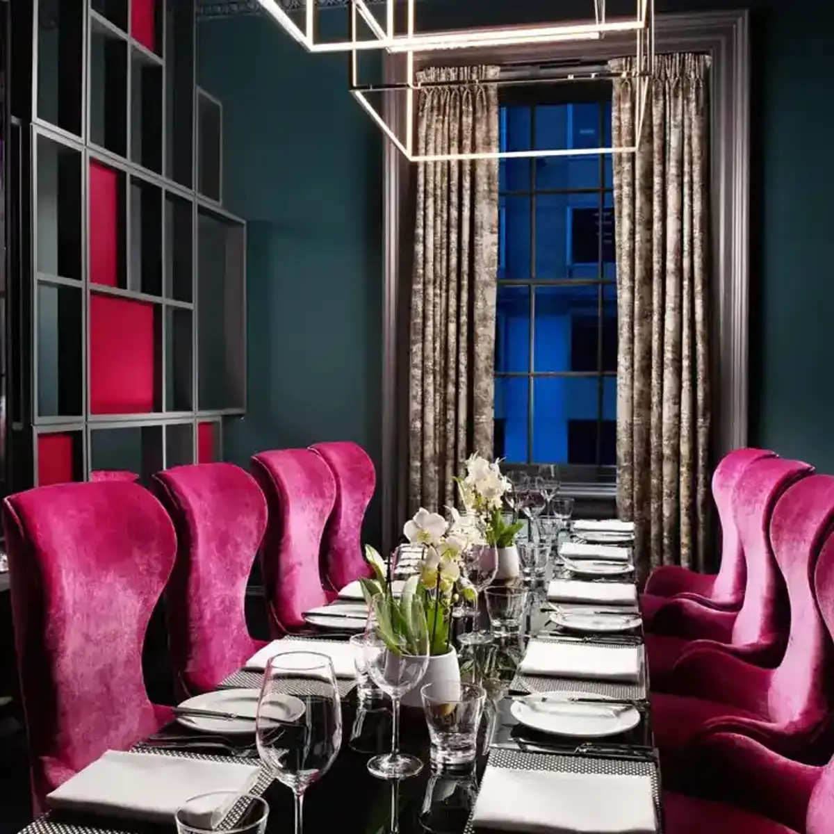 Private dining room with fuchsia velvet decor for VIP dinners and executive board meetings.
