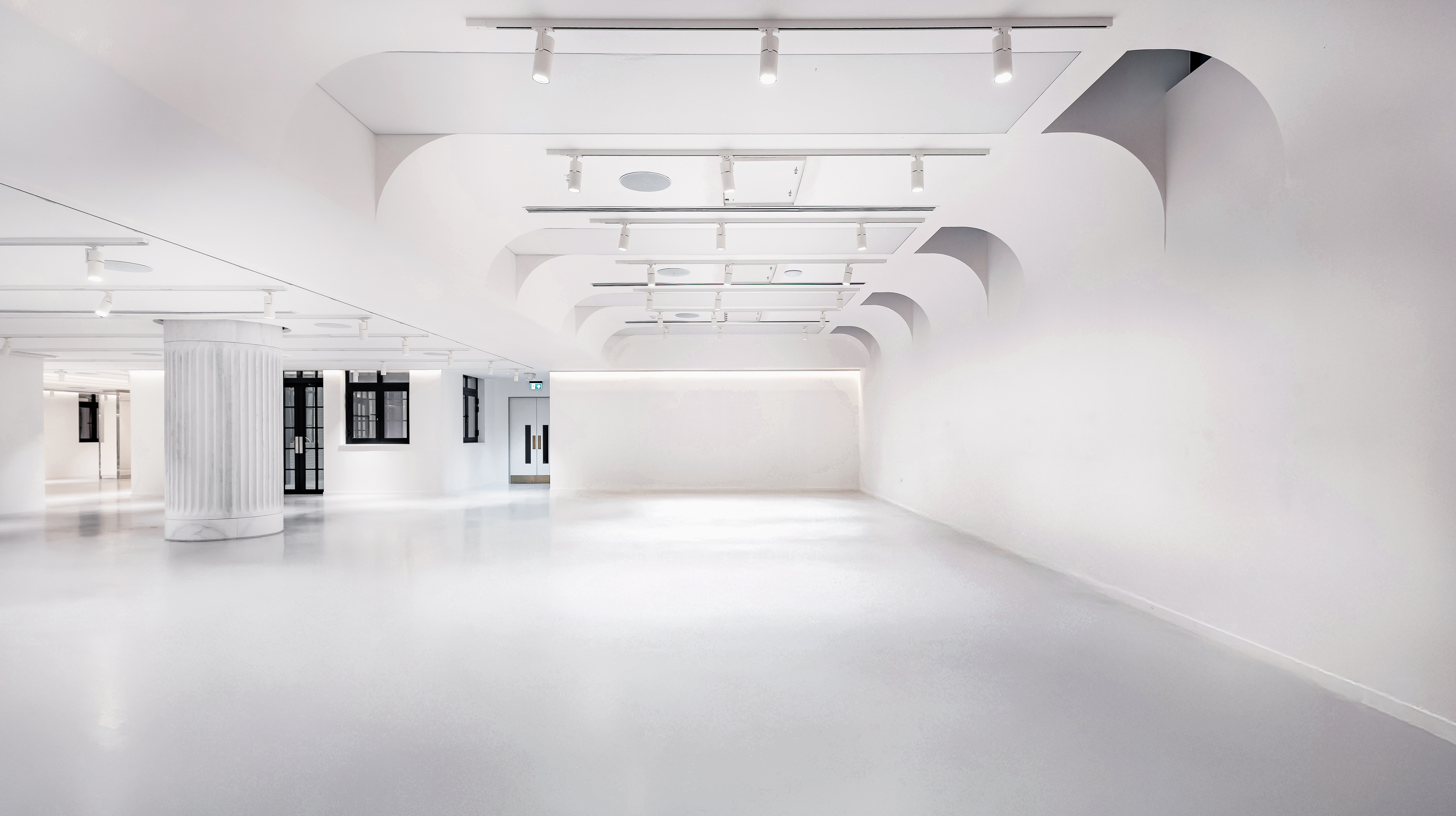 Minimalist white event space for product launch or exhibition