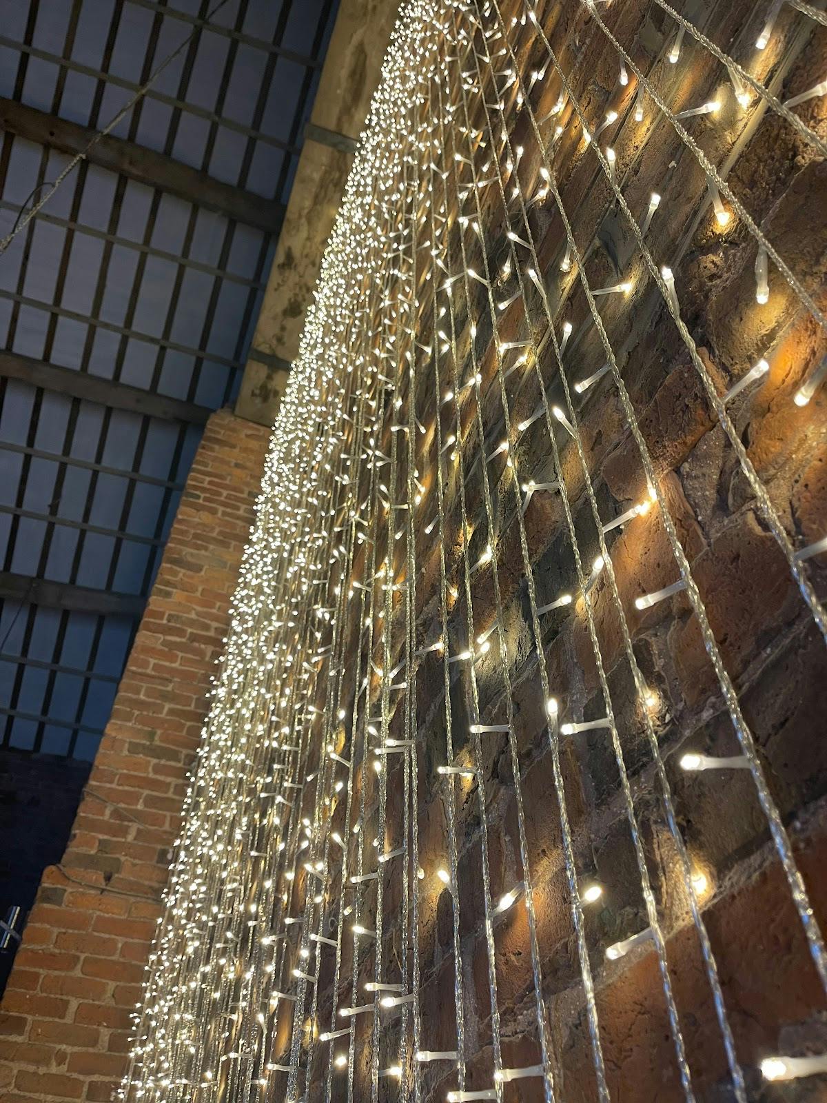 Fairy light curtains at The Barn at Morleys Hall for rustic wedding or industrial event venue.