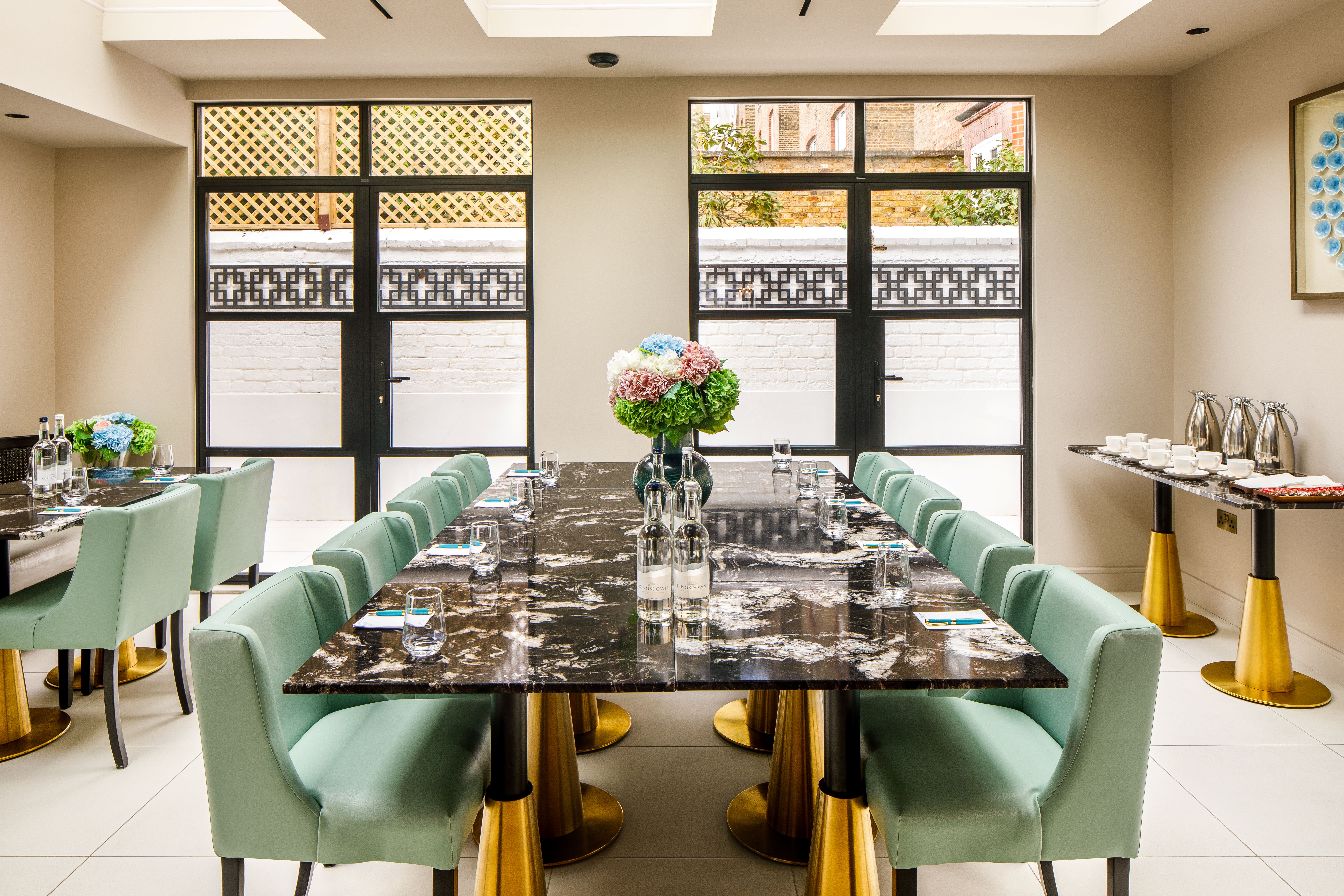 Luxury private boardroom at Ellen Kensington with marble table for executive meetings and events.