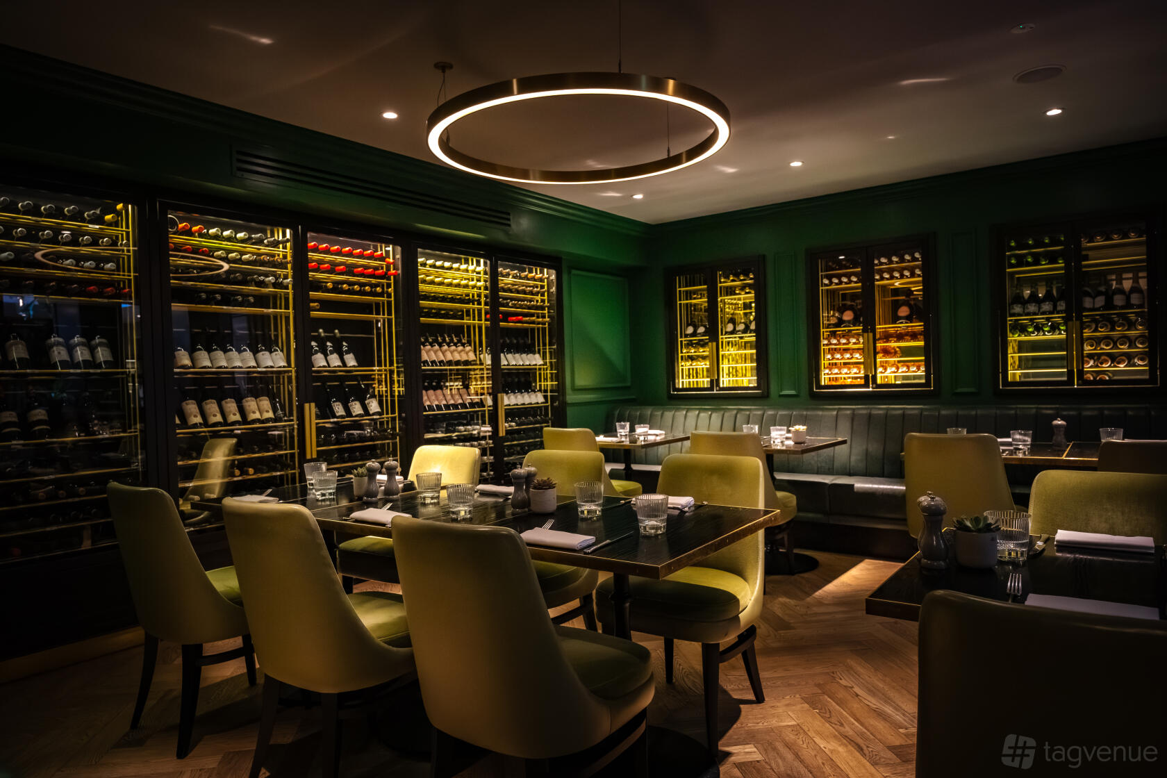 Luxury private dining at The Wine Room, 11 Cadogan Gardens featuring moody lighting and wine wall.