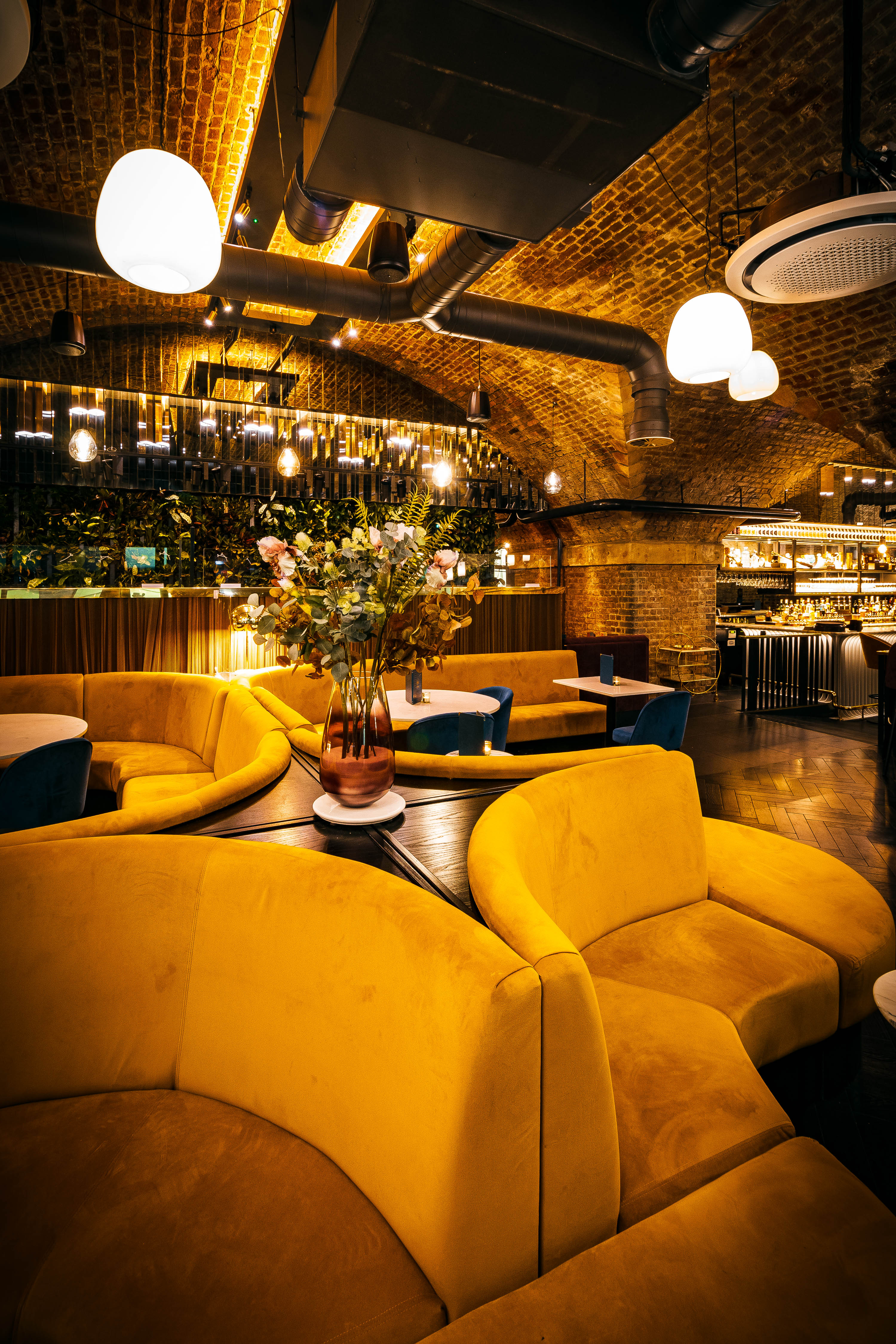 Lounge Arch booth seating at Spirit of Manchester Distillery for upscale networking events.