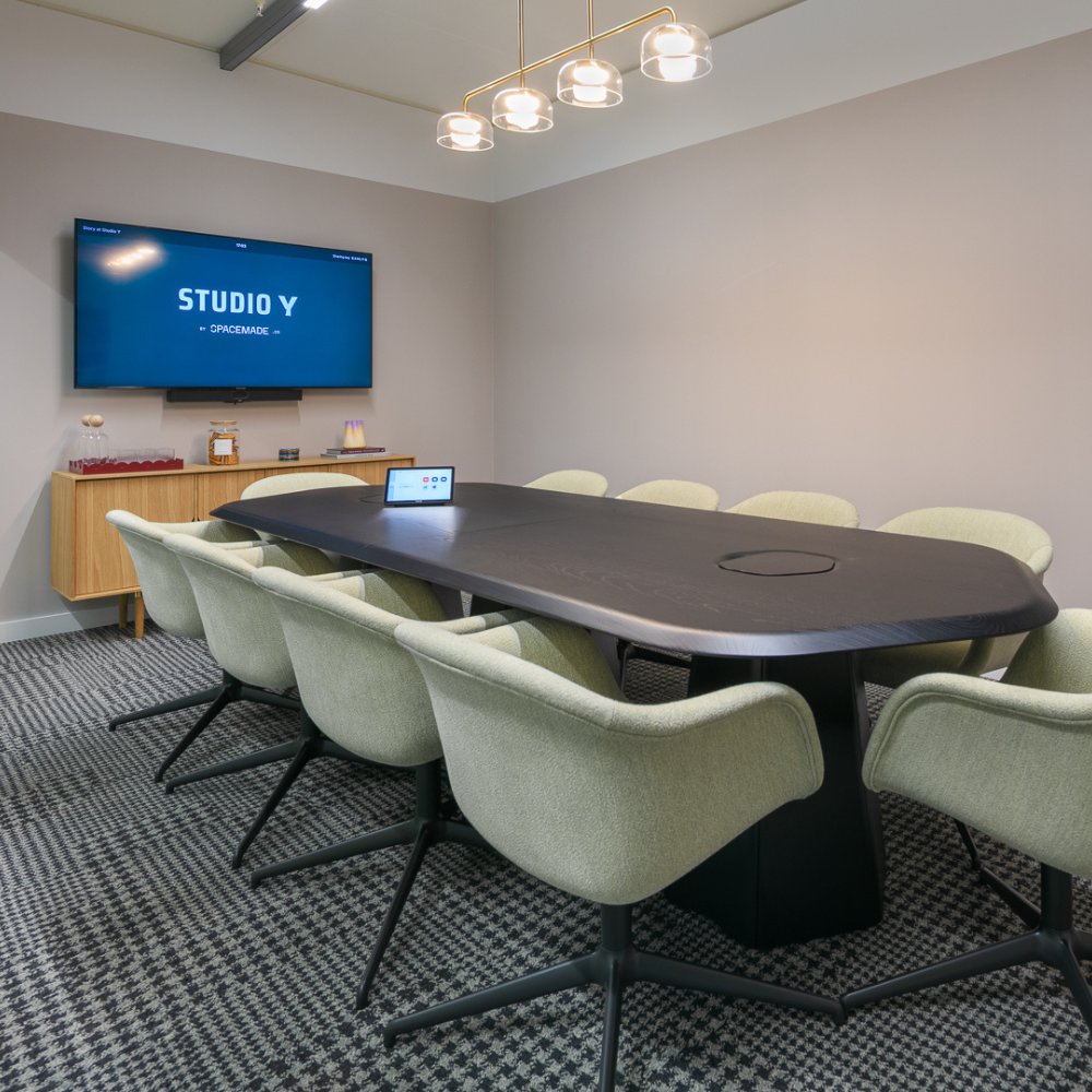 Studio Y boardroom with AV display for professional hybrid meetings and strategy sessions.