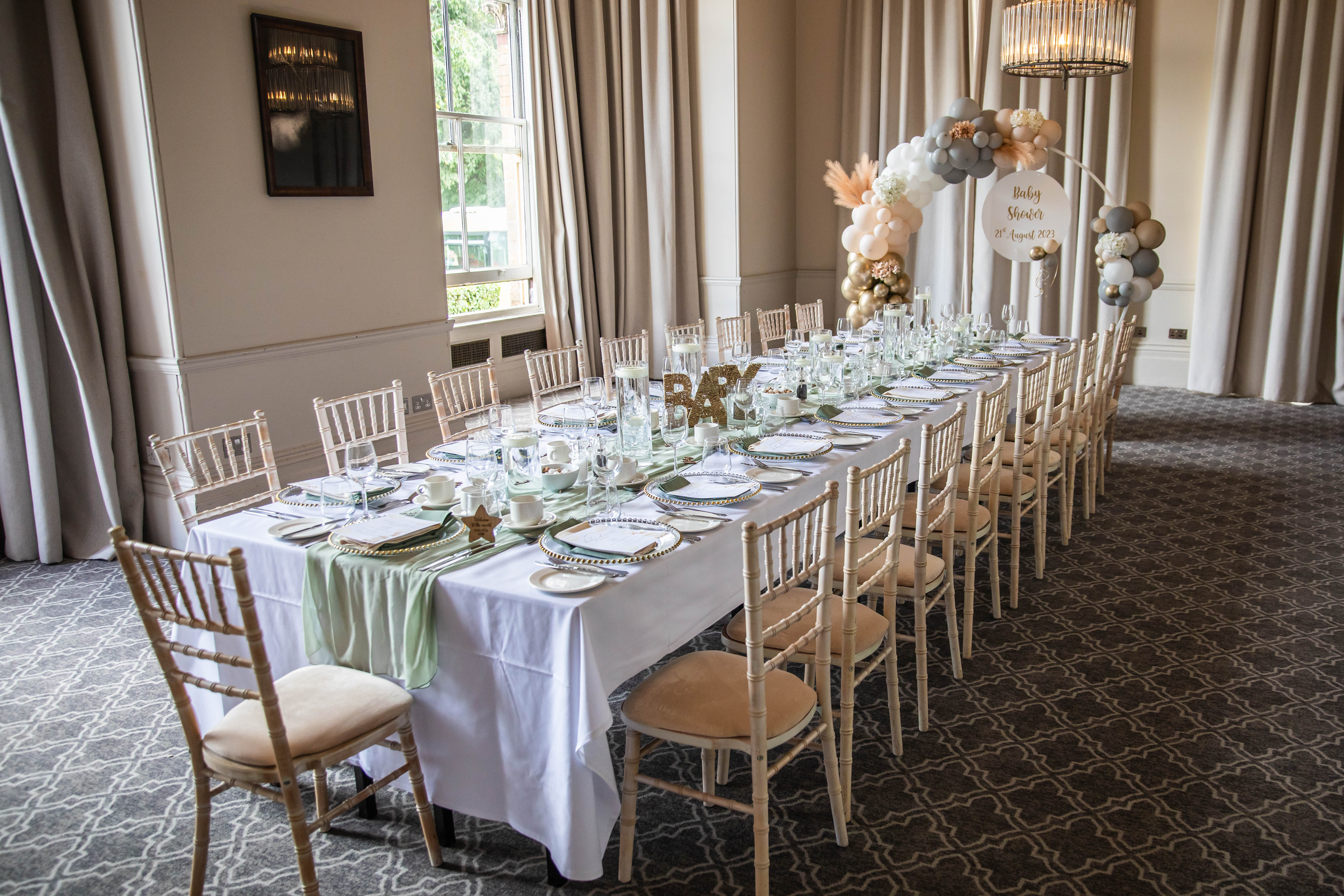 Elegant long table setup with chic decor for weddings and corporate events.
