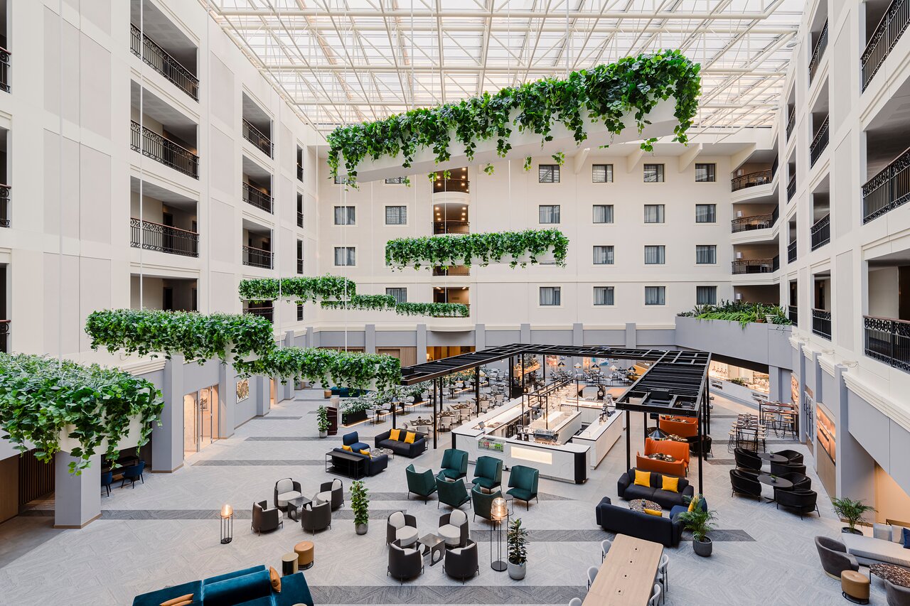 Light-filled cafe atrium for professional networking and corporate event receptions. - Banner