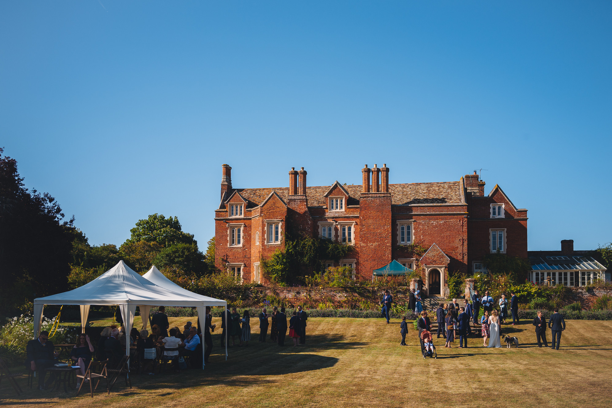 Tented outdoor reception at Childerley Hall manor house, ideal for garden weddings and events.