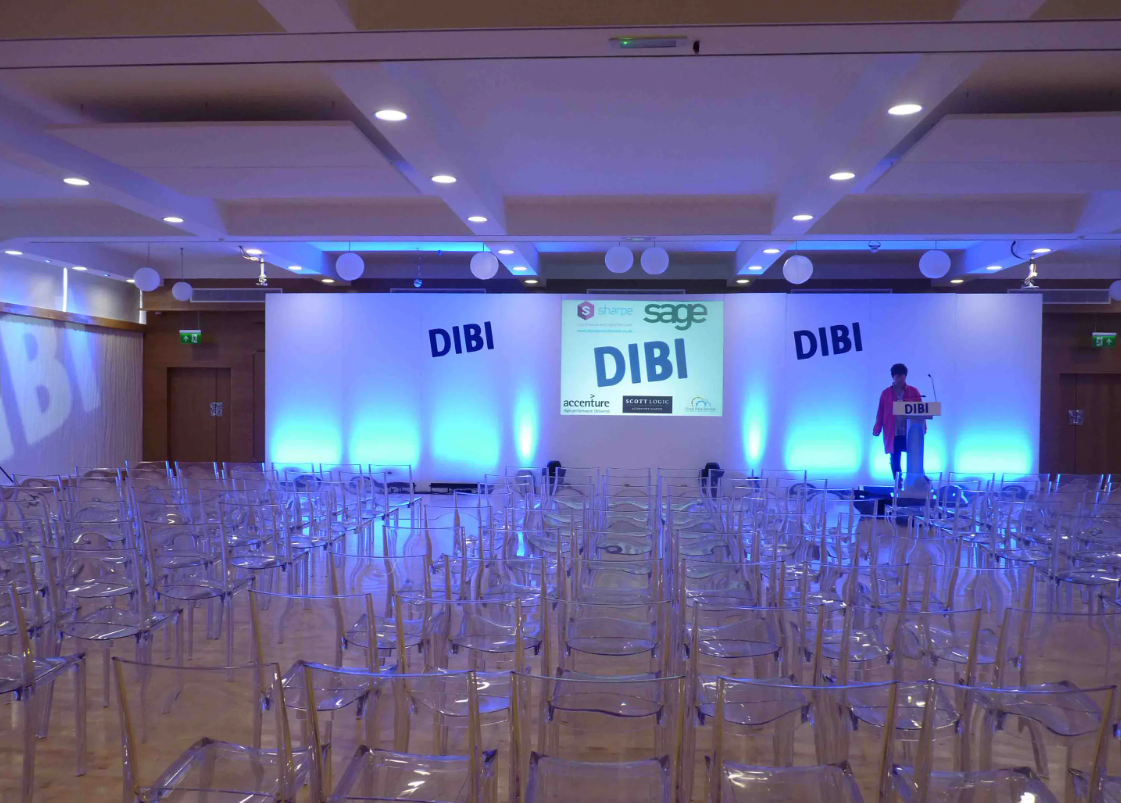 Modern conference space at The Biscuit Room, Birmingham with clear chairs and vibrant lighting.
