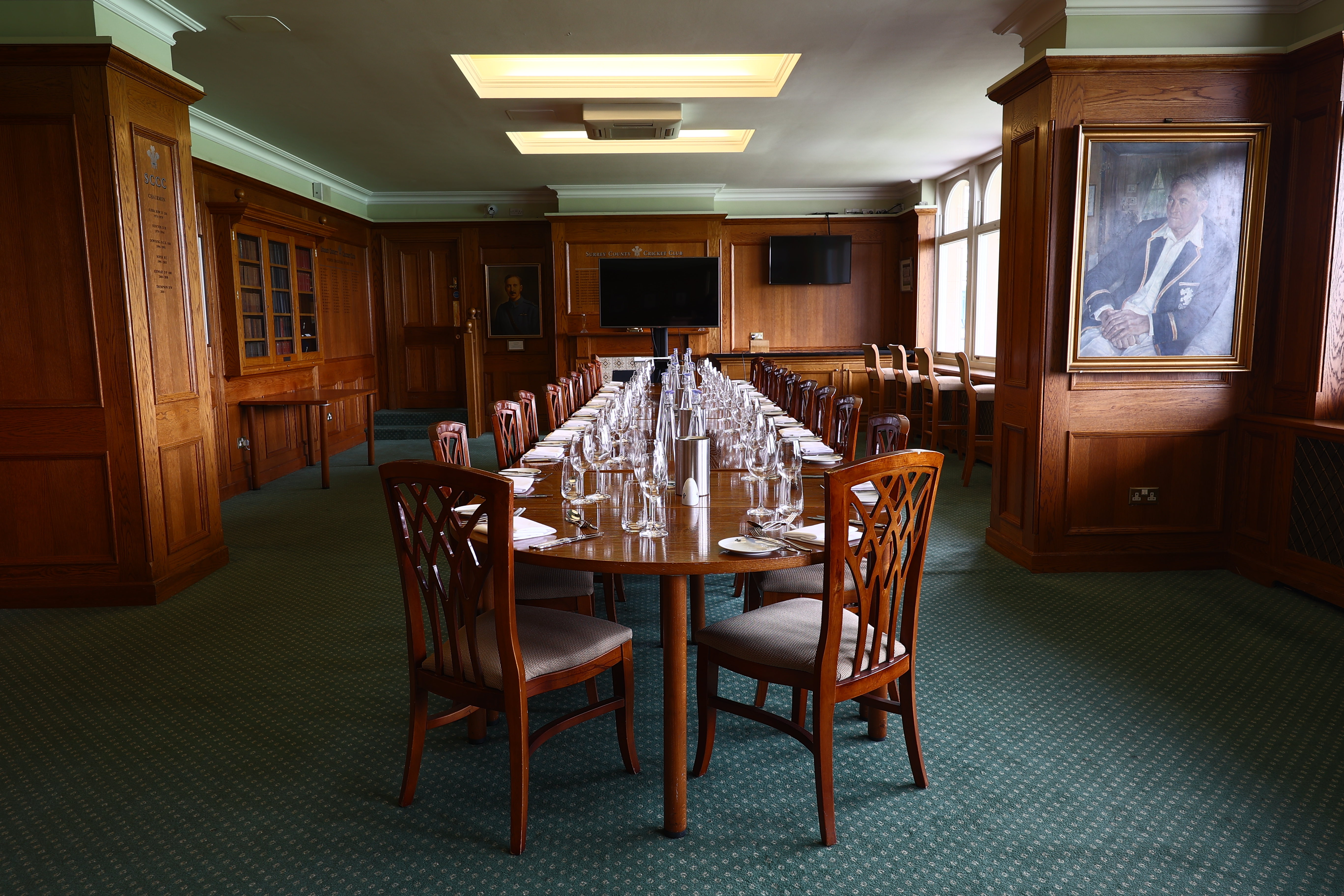 Kia Oval wood-paneled boardroom for formal dining and executive meetings.