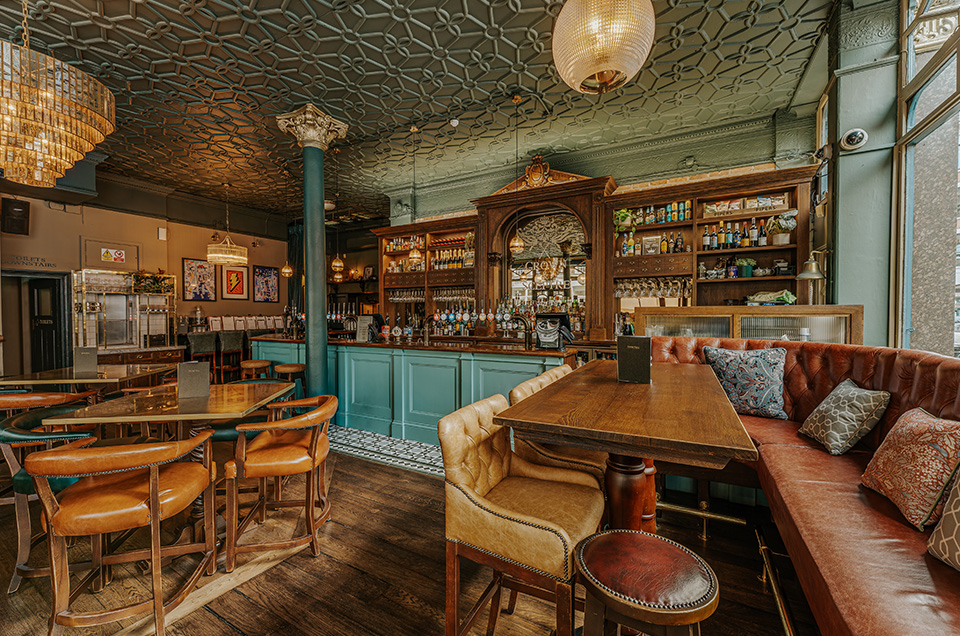 The Crown & Sceptre gastropub interior with plush banquettes for corporate mixers and events.