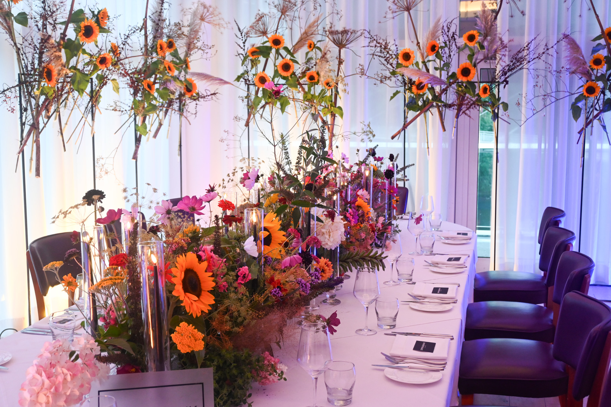 Luxury private dining room with floral centerpieces for premium corporate events and gala dinners.