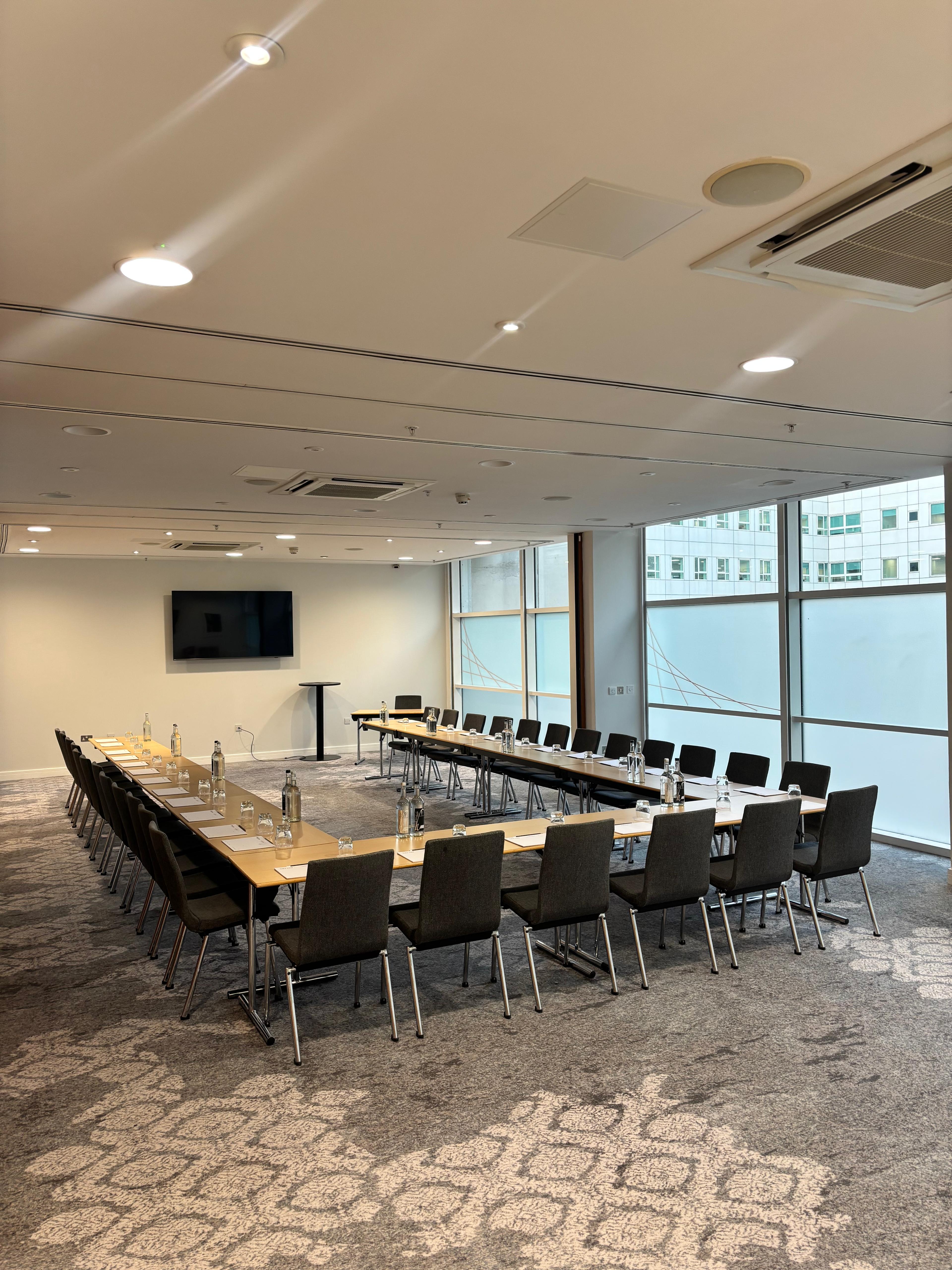U-shape meeting room setup at The Lowry Hotel for corporate workshops and board meetings.