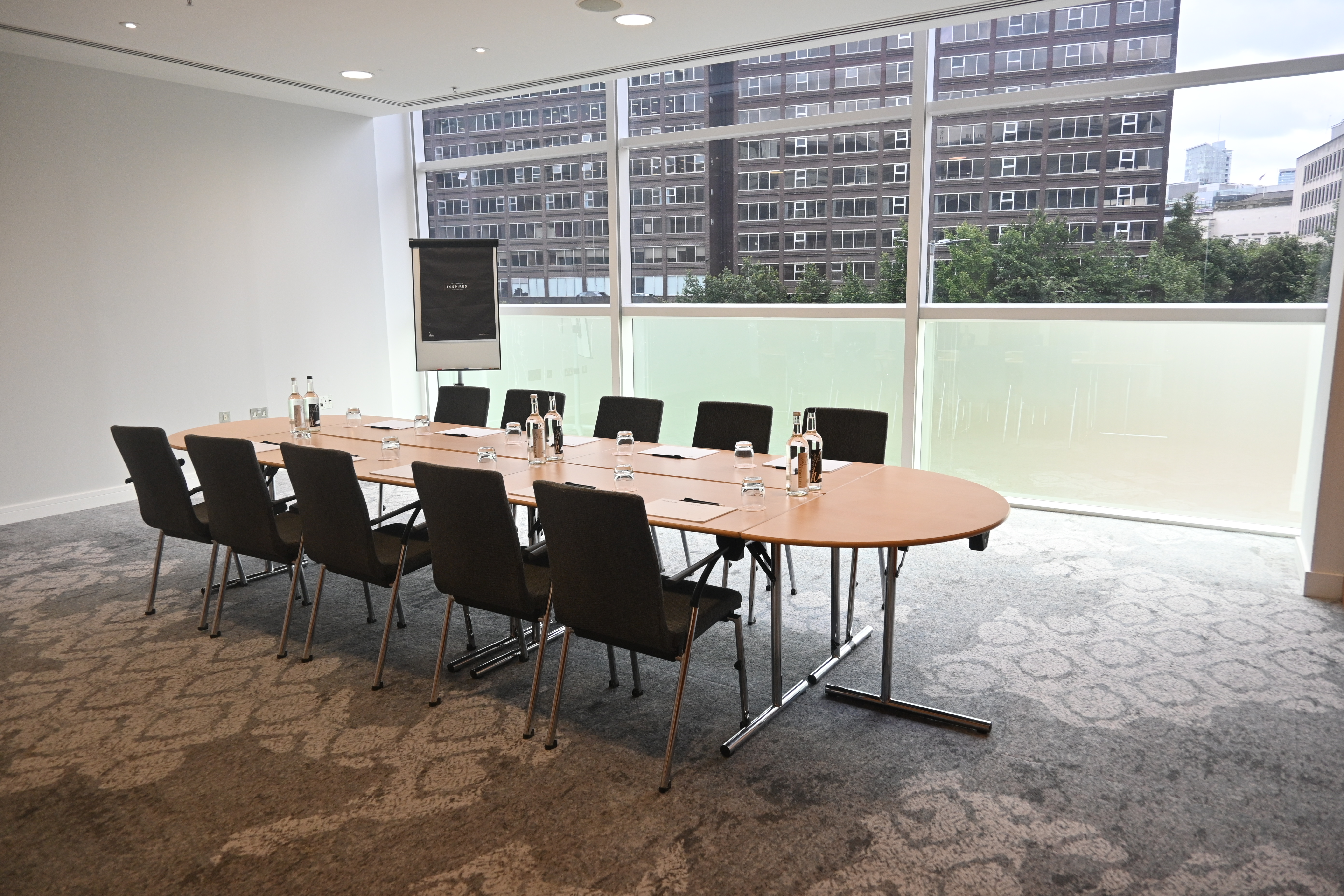 Boardroom-style Meeting Room 7 at The Lowry Hotel, perfect for professional business conferences.