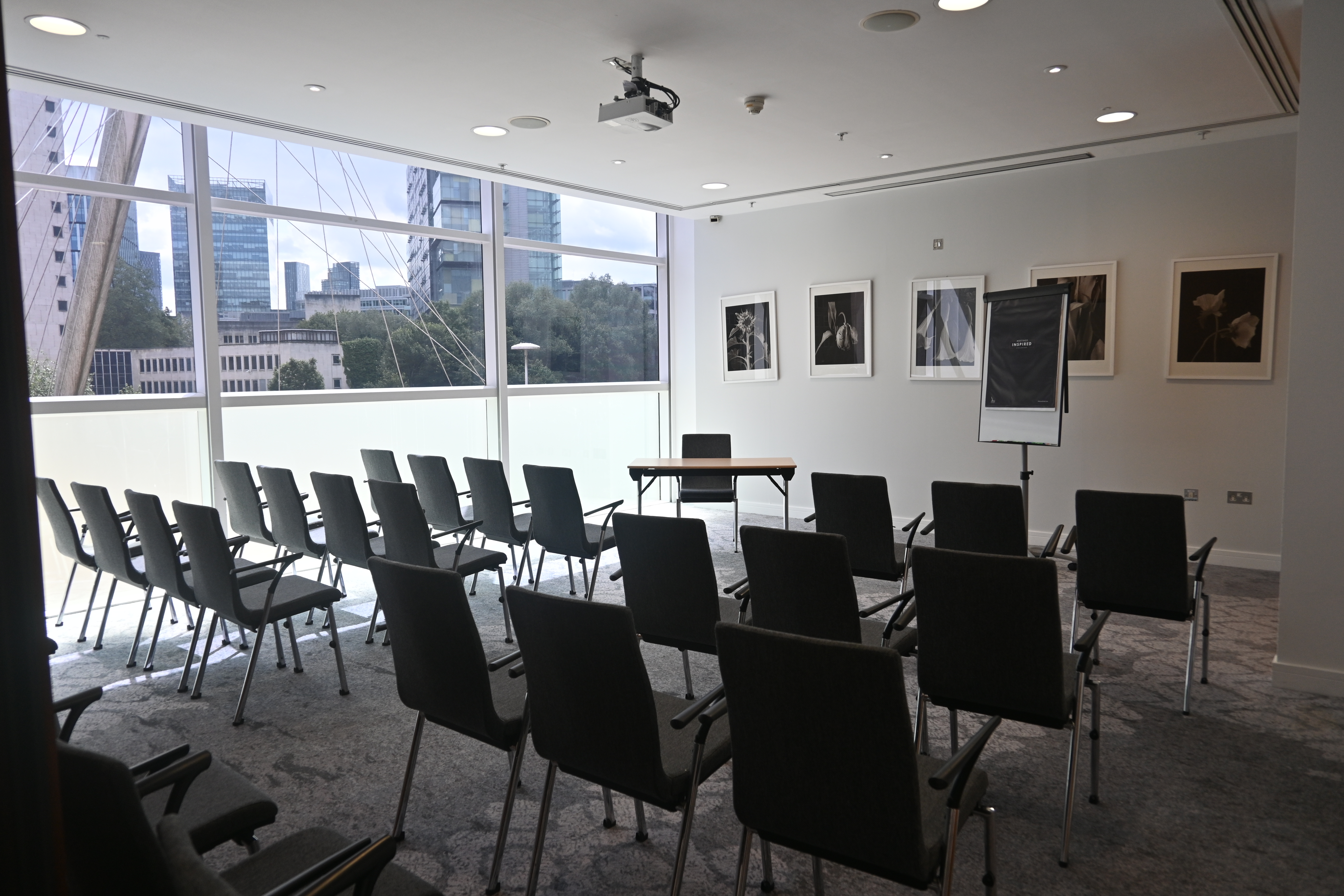 The Lowry Hotel Meeting Room 8, theater-style setup with floor-to-ceiling windows for events.