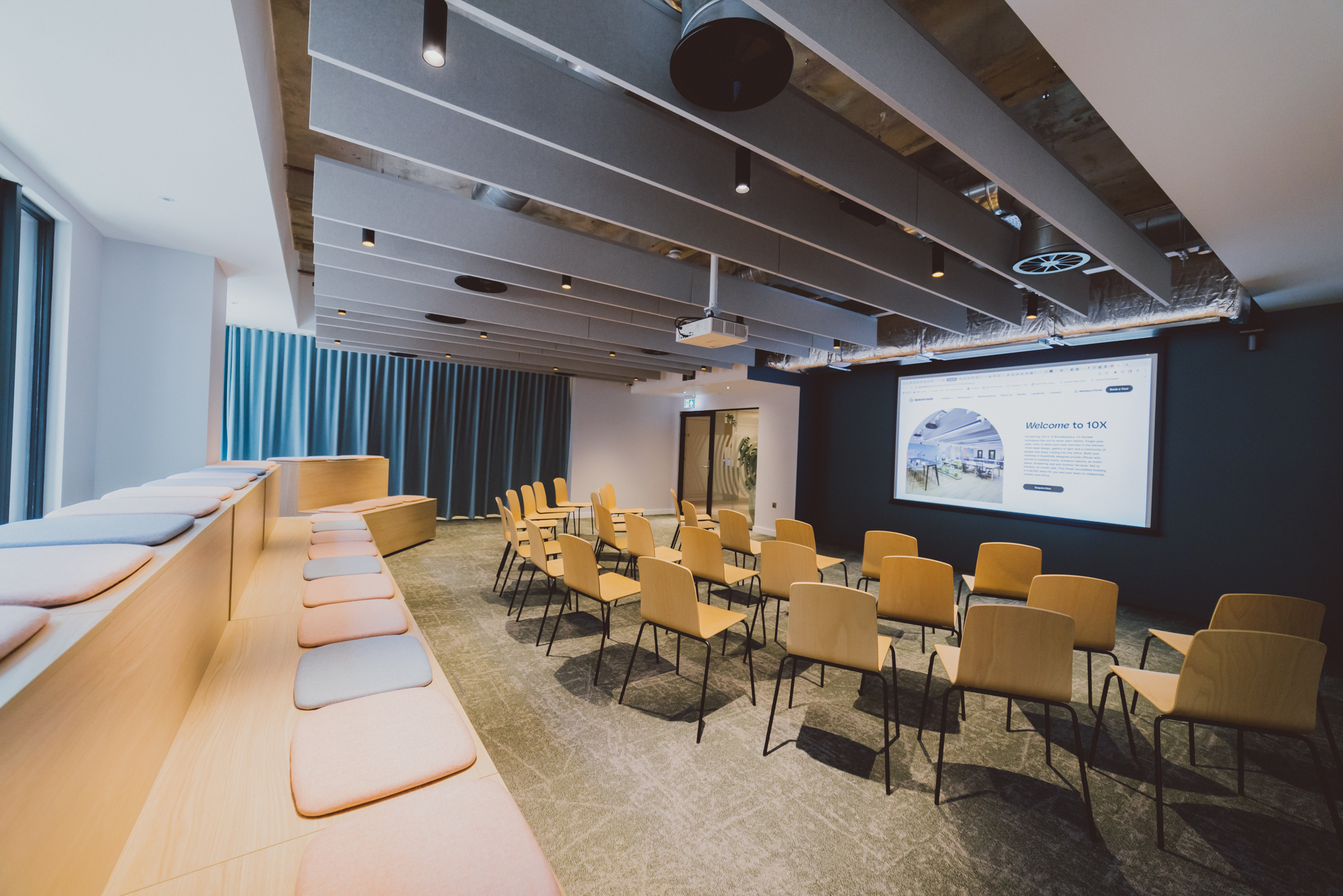 Modern 10X Lounge with tiered bench seating for interactive workshops and corporate events.