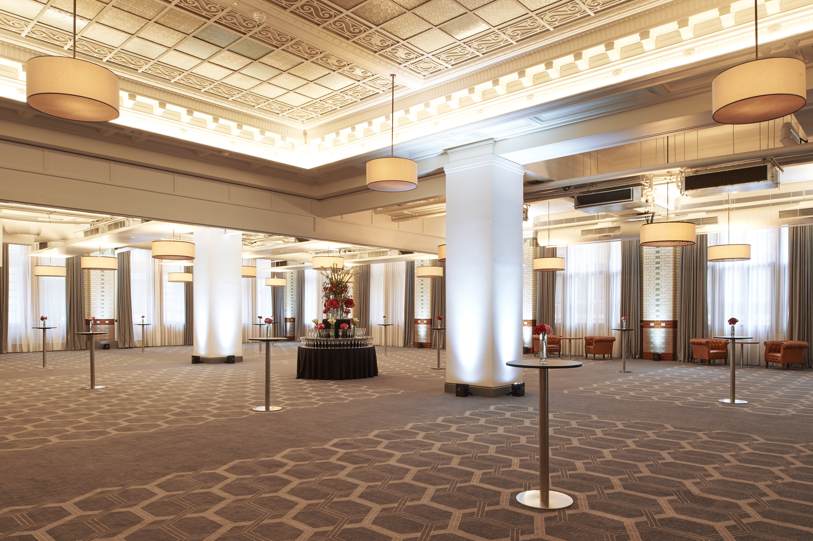 Elegant event venue at Kimpton Clocktower Hotel with high ceilings for corporate gatherings.