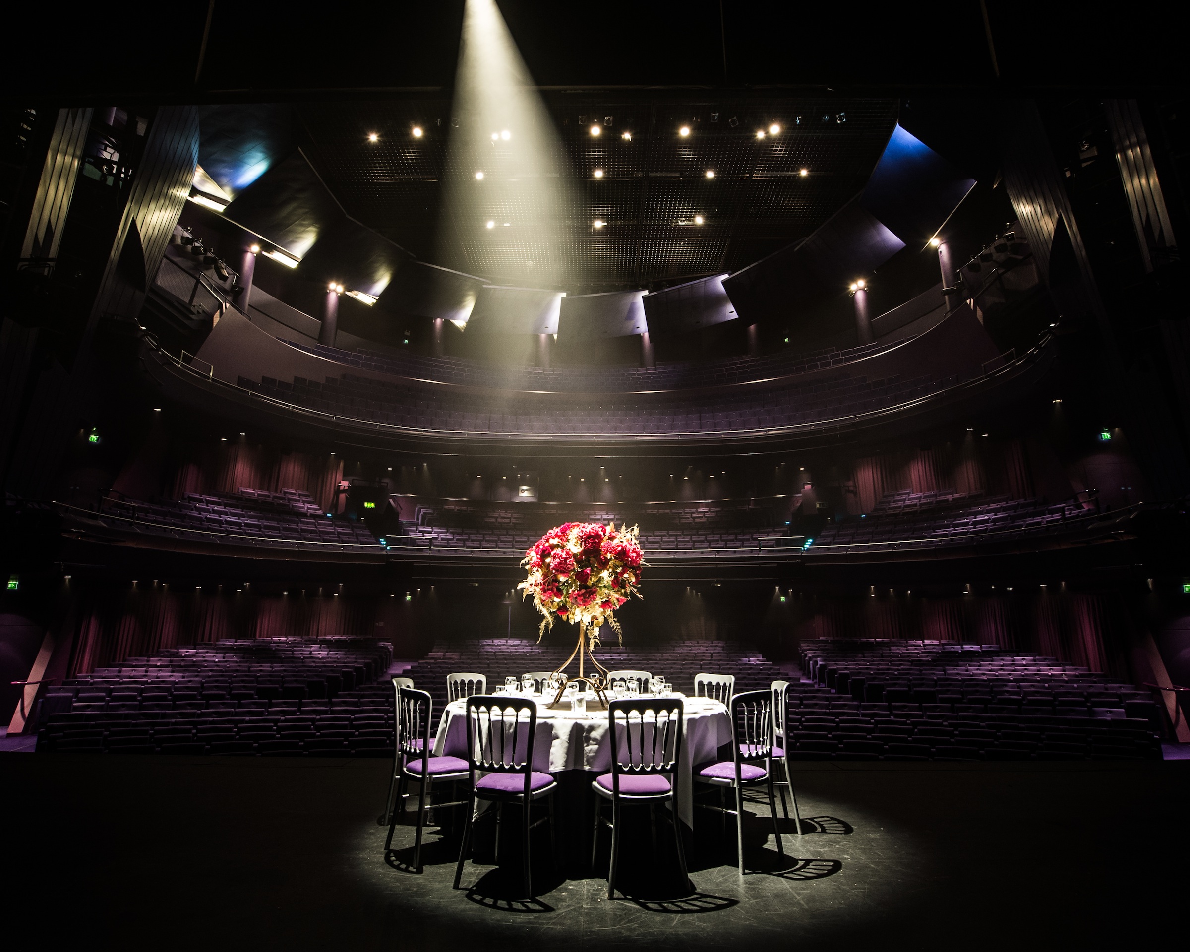 Elegant table with floral centerpiece at Lyric Theatre, perfect for gala dinners and award ceremonies.