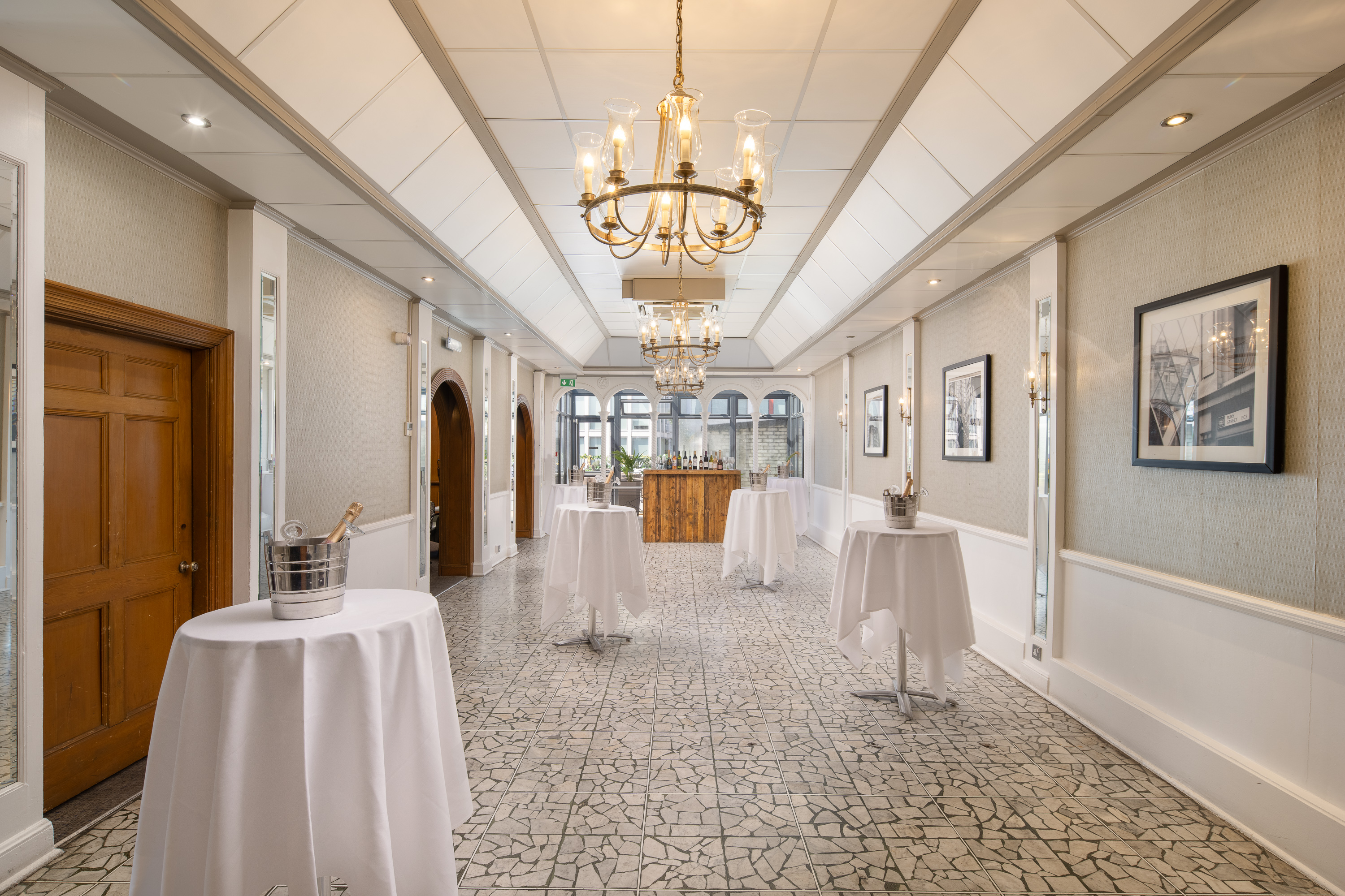 Cocktail reception at Grand Connaught Rooms Penthouse with bar and high-top tables.