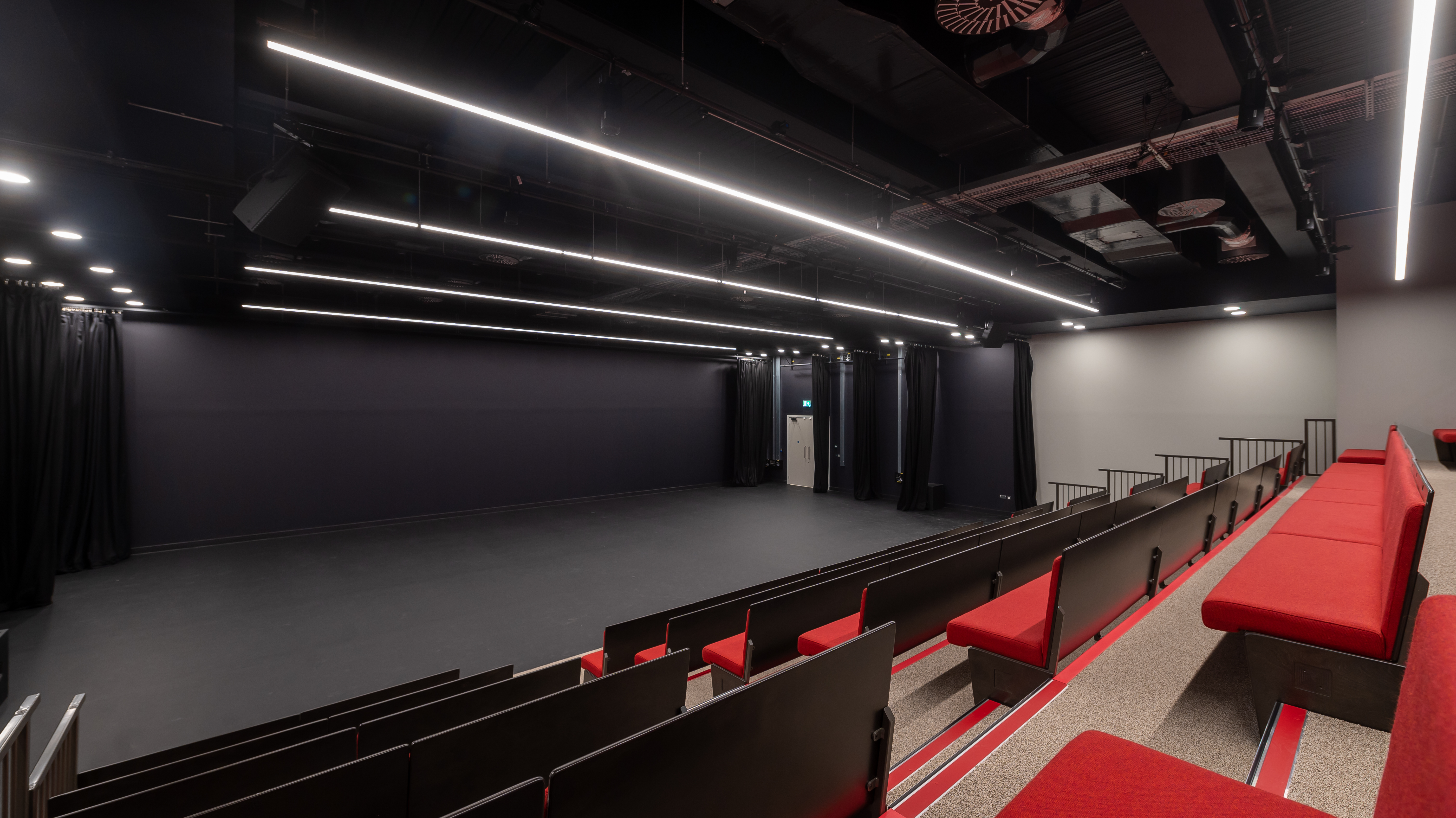 Versatile event space with tiered seating at Royal Academy of Dance for presentations and performances.