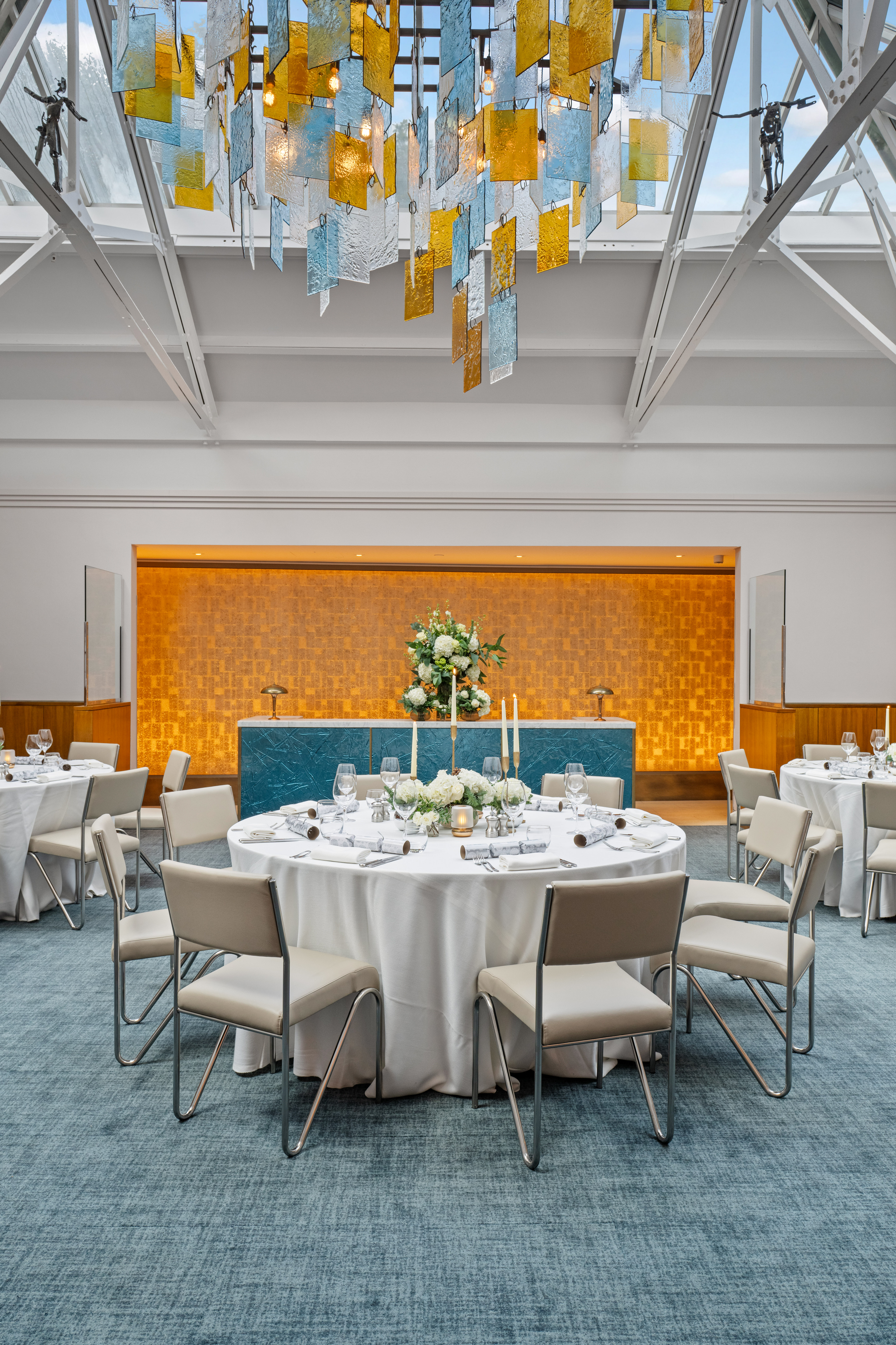 Elegant event space in Bluebird Chelsea with round tables and stylish bar for gatherings.