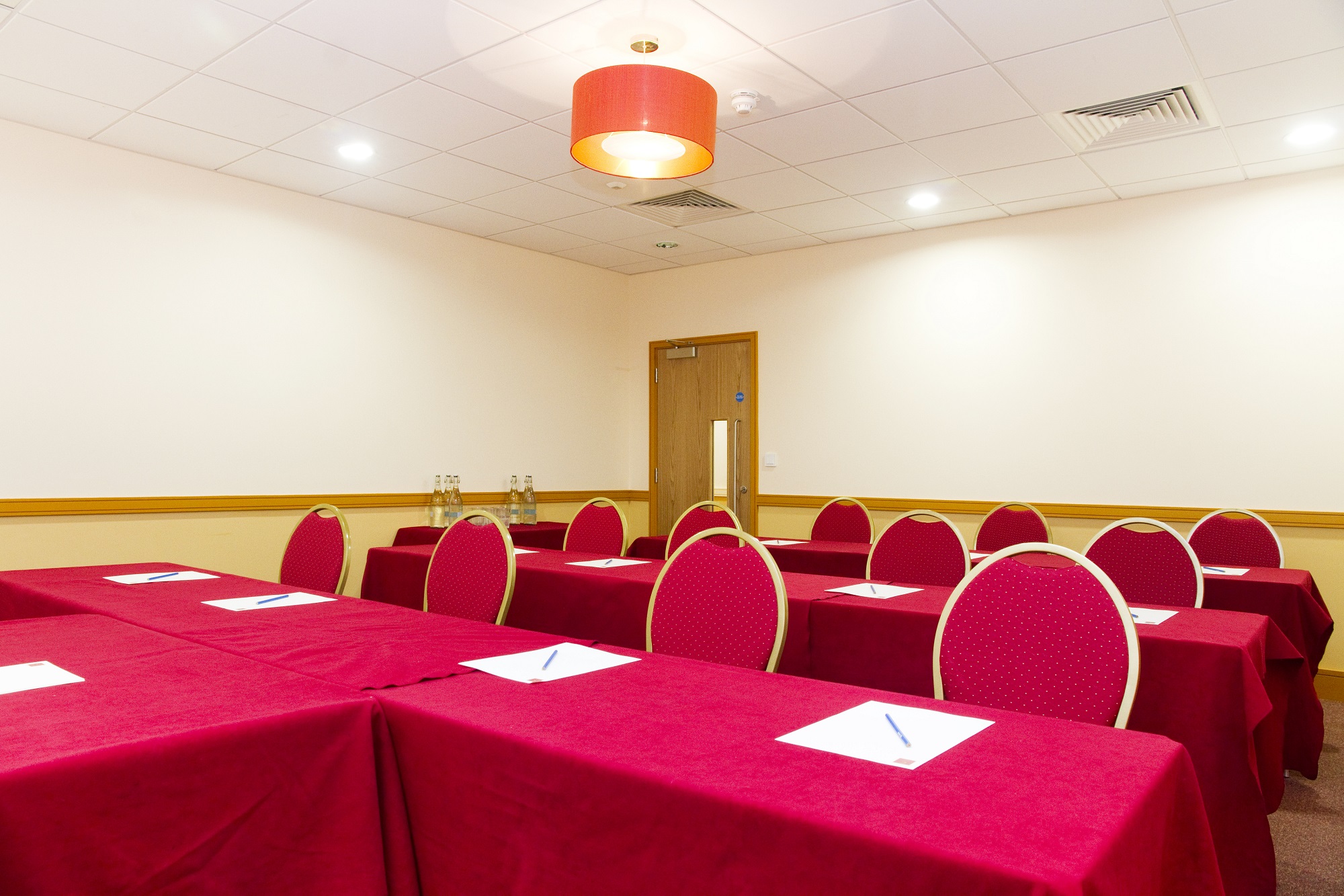 The Keys Room in Clerkenwell: red-linened classroom for training sessions and corporate meetings. - Banner