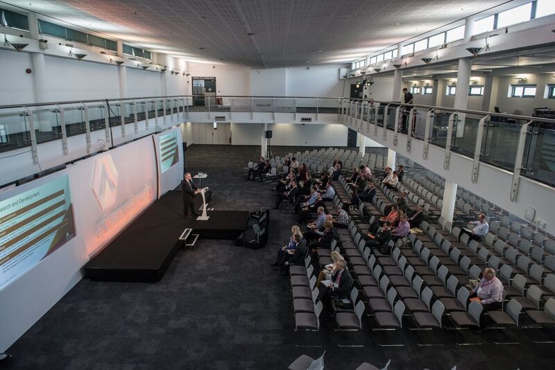 Spacious conference venue with stage and seating for impactful business events.